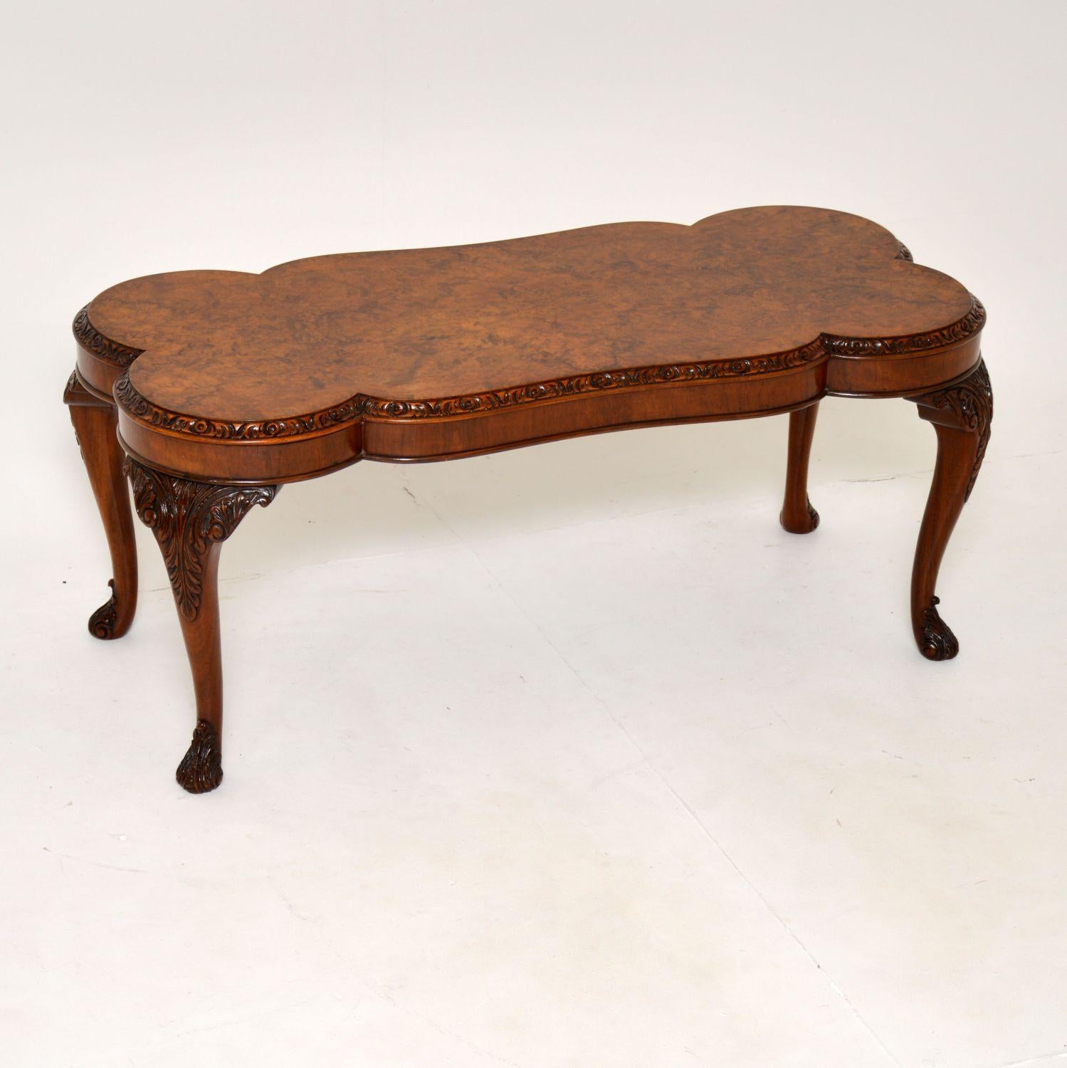 A gorgeous antique Queen Anne style coffee table in burr walnut, made in England & dating from the 1930’s period.

The quality is absolutely superb, with a stunning shaped top and amazing carving to the edges and legs. It is a great size and is