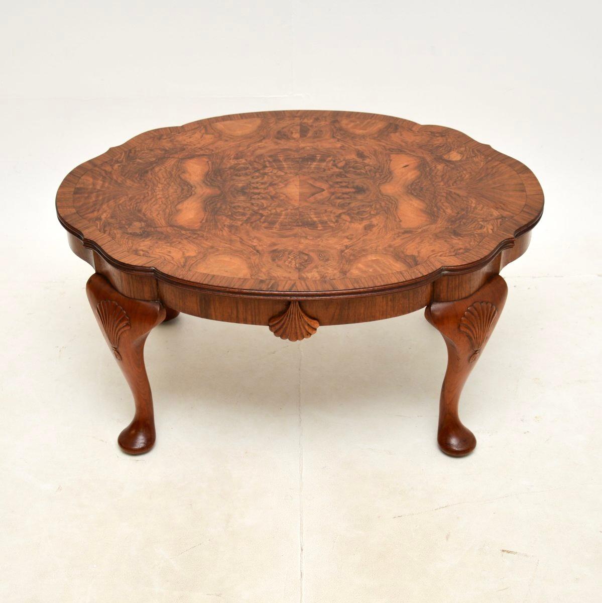 A fantastic antique burr walnut coffee table. This was made in England, it dates from around the 1900-1920 period.

The quality is superb, this has a beautifully shaped top with cross banded edges and stunning burr walnut grain patterns. It sits on
