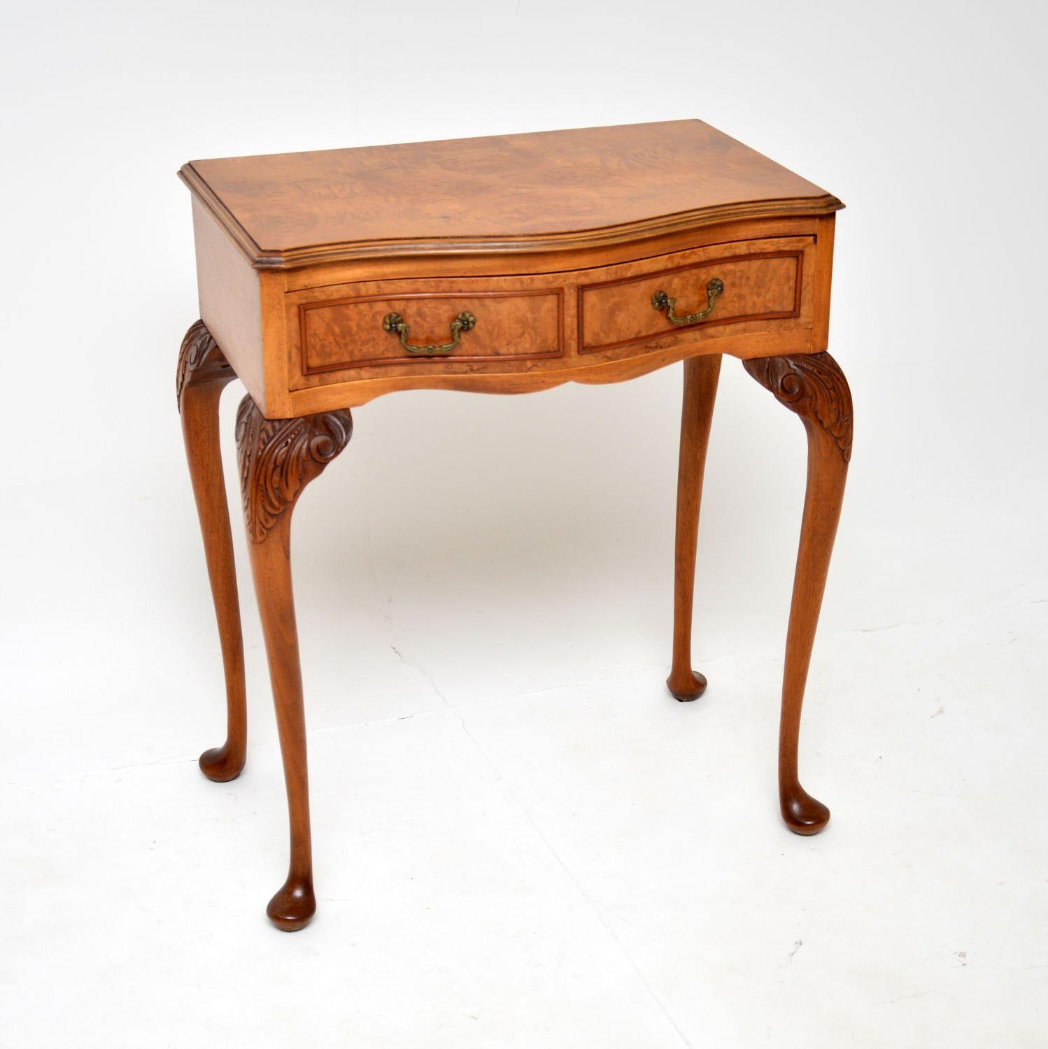 A gorgeous antique side table in burr walnut. This is in the Queen Anne style, it was made England and dates from around the 1930’s.

It is of lovely quality and is a useful size, perfect for use as a console or side table in various places around