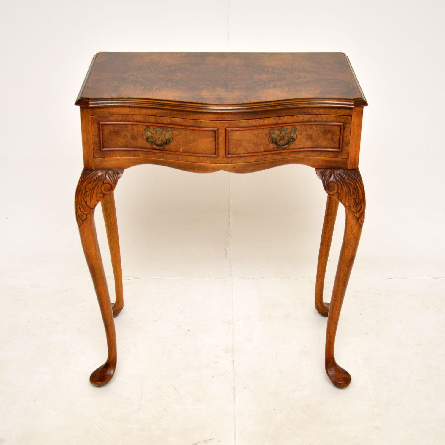 A gorgeous antique burr walnut side table in the Queen Anne style. This was made in England, it dates from around the 1930s.

The quality is superb, this has a beautifully shaped serpentine front and sits on cabriole legs with acanthus leaf