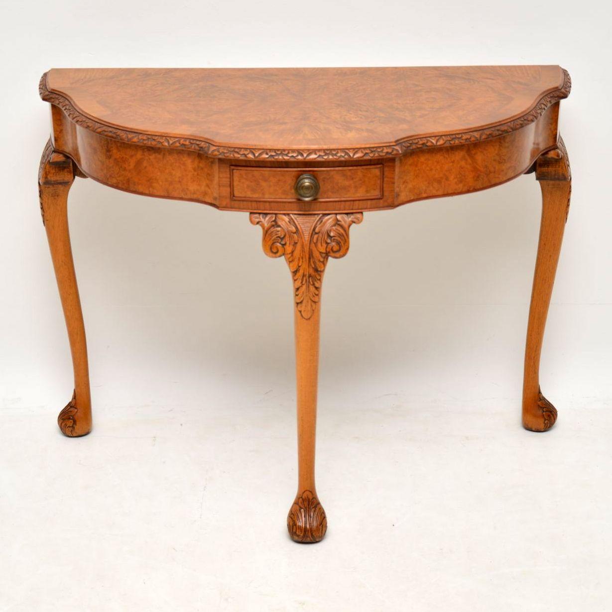 Very impressive well shaped burr walnut console side table in good condition & having a lovely colour. It has a single drawer in the middle, a carved top edge, with more carvings on the legs & feet. This console table is Queen Anne style & dates