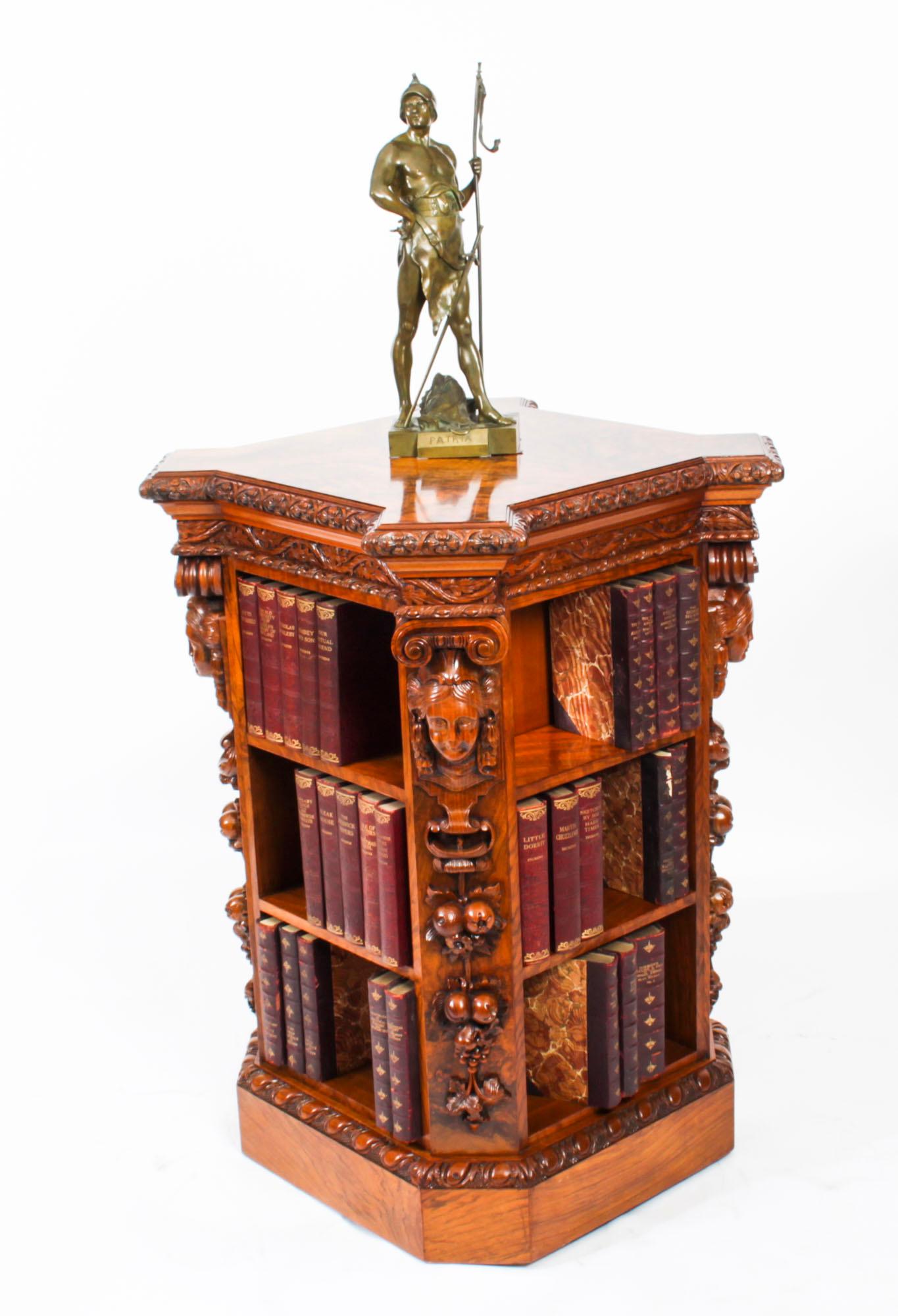 This is an exquisite antique early 19th century figured walnut freestanding library bookcase, in the manner of Gillows, circa 1820 in date.

This exquisite carved bookcase is of square shape with a stunning figured walnut top of incredible quality