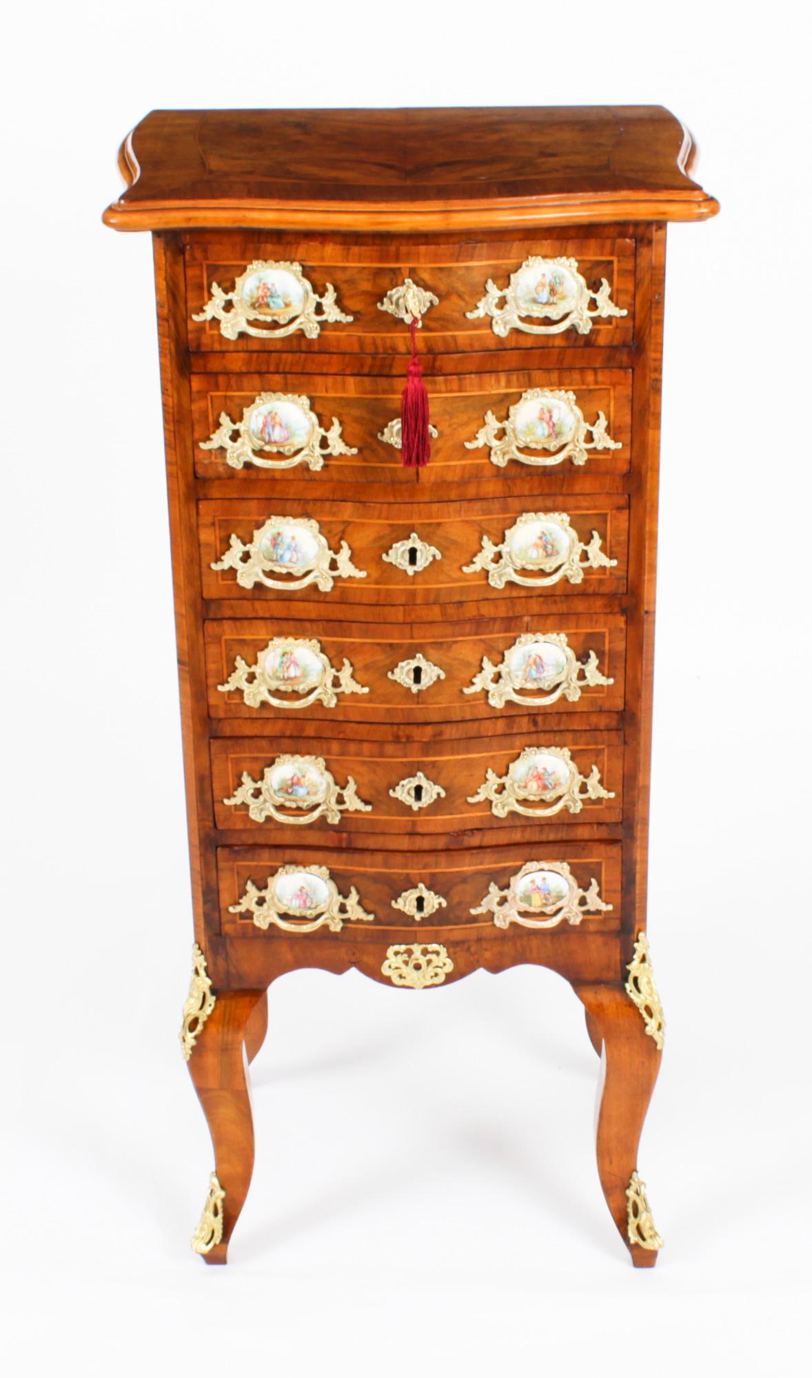 A stunning antique French serpentine fronted burr walnut chest of six drawers Circa 1870 in date.
 
Crafted from the most beautiful burr walnut with inlaid decoration and ormolu mounts. It has stunning ornate foliate ormolu handles with inset oval