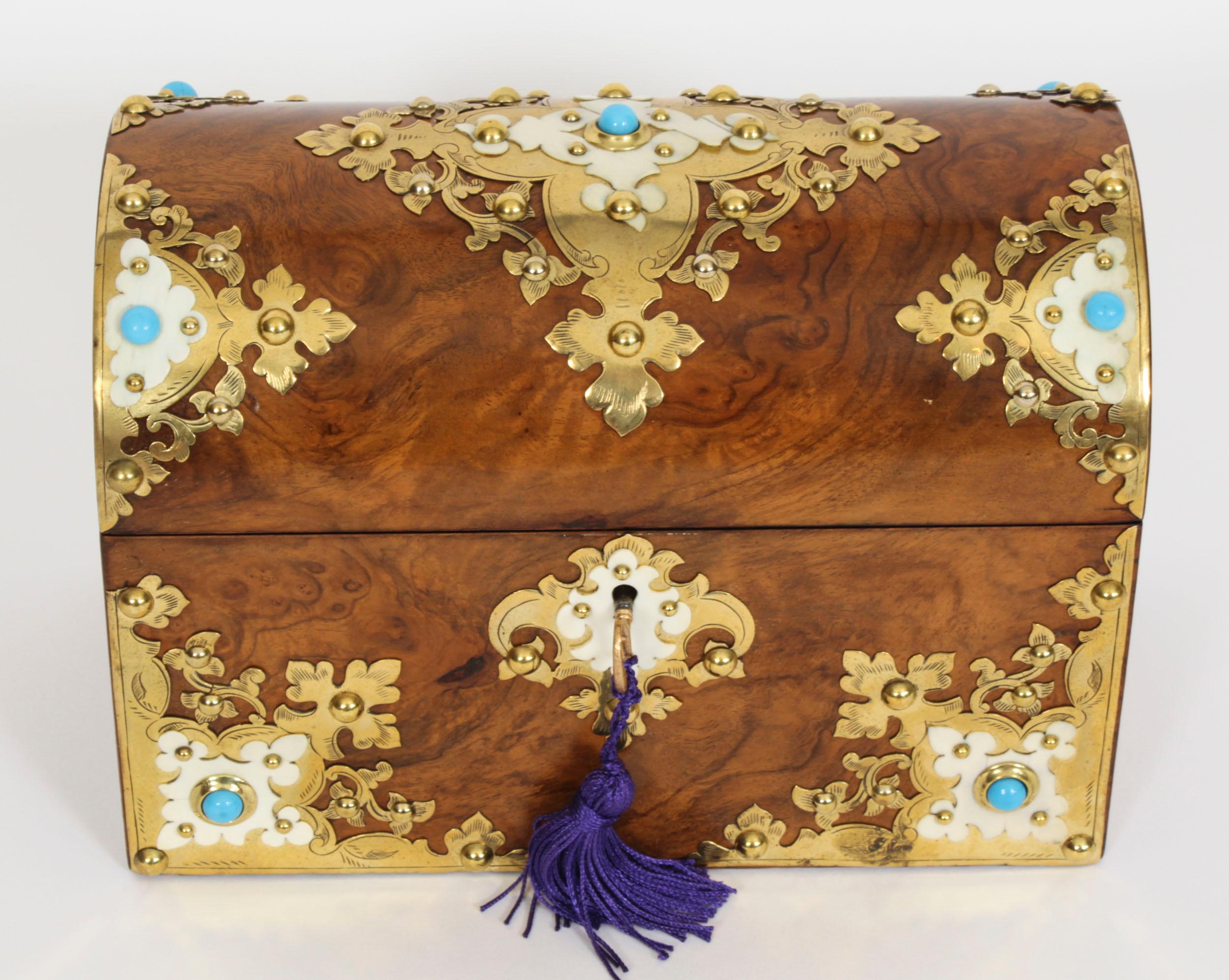 This is a wonderful antique Victorian burr walnut, ivorine, brass and turquoise bead mounted casket, circa 1870 in date.

This wonderful casket has a domed hinged lid with elaborate studded brass fret-work enhanced with ivorine and turquoise bead