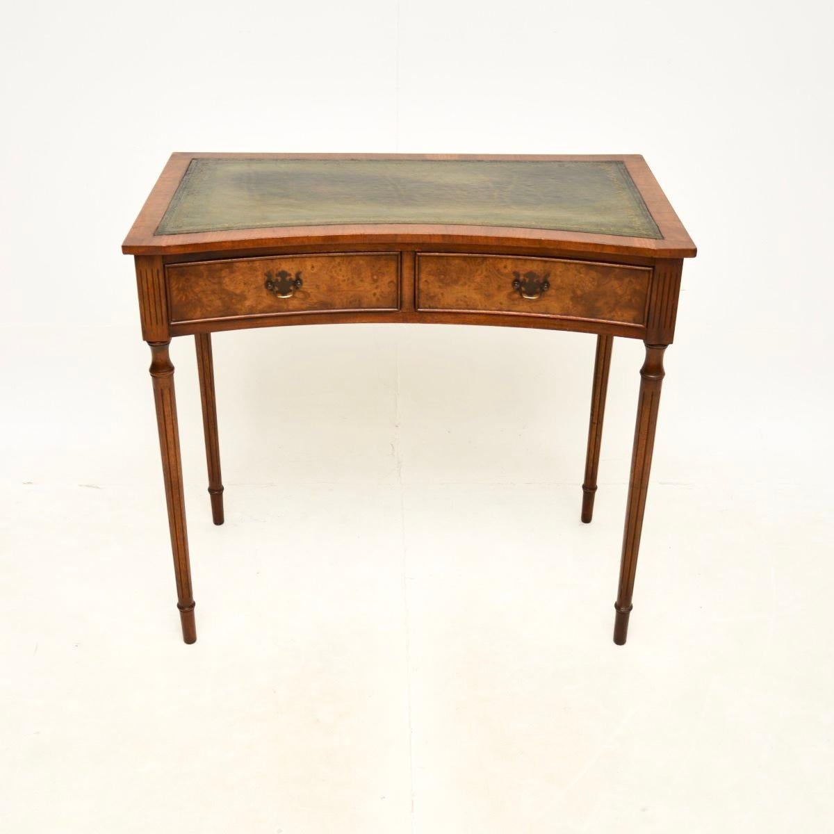A lovely antique burr walnut leather top concave desk / side table. This is in the Georgian style, it was made in England, and dates from around the 1930’s.

It’s of great quality and is a very useful size, perfect for use as a writing desk or as an