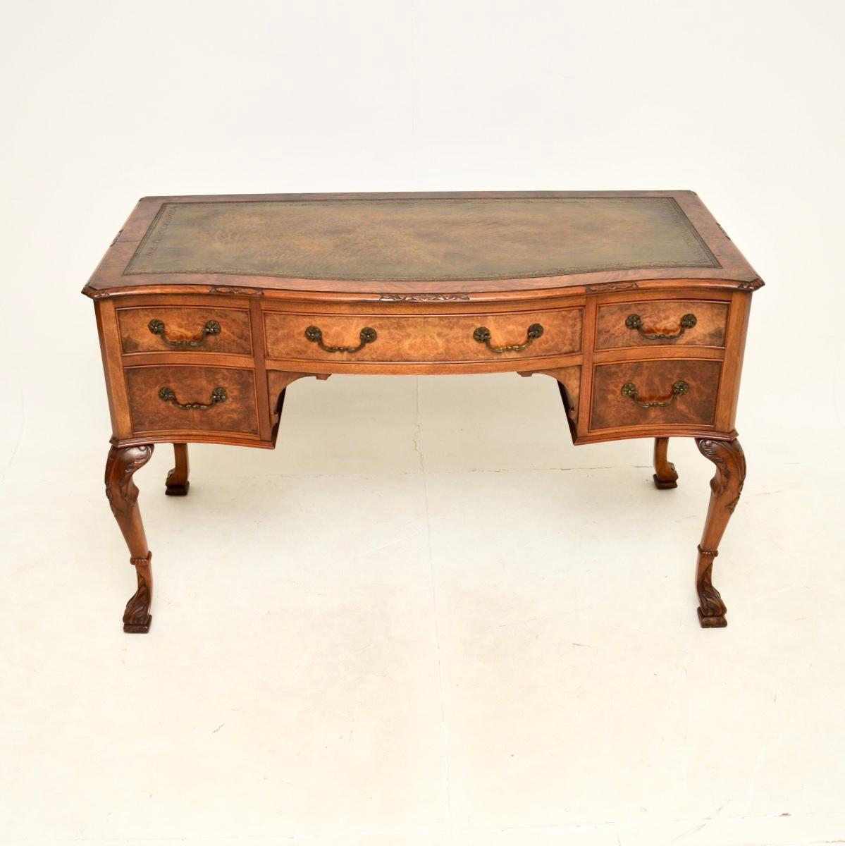 An impressive and extremely well made antique burr walnut leather top desk. This was made in England, it dates from around the 1900-20 period.

The quality is outstanding, this has stunning burr walnut grain patterns and crisp carving on the