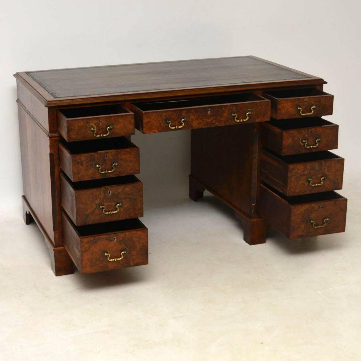 Very impressive antique walnut leather top pedestal desk which separates into three sections for easy transportation. The top has a tooled hand coloured leather writing surface, surrounded by a burr walnut edge. All the drawers are graduated in