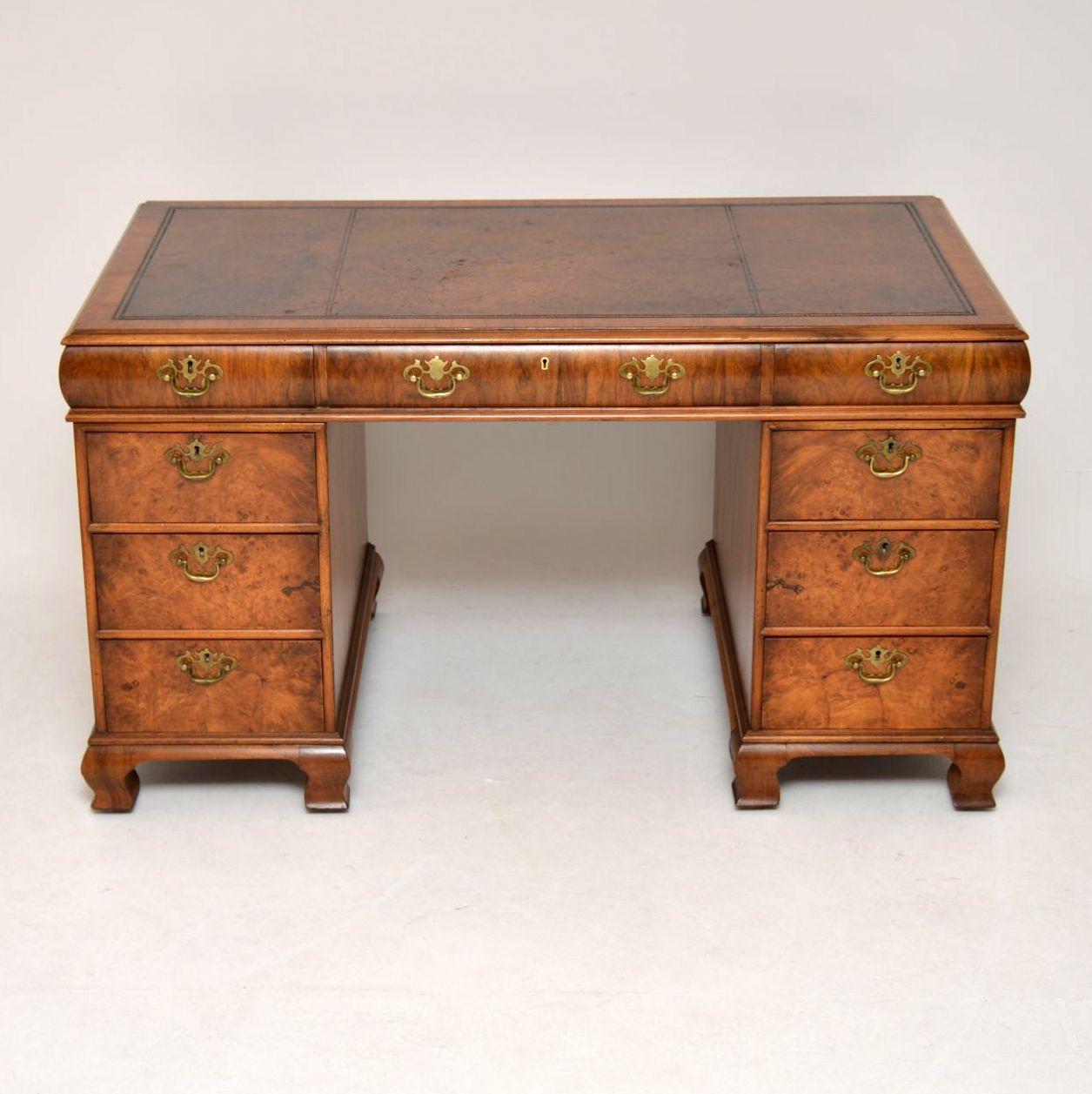This is a stunning walnut pedestal desk in good original condition and dating to circa 1910s-1920s period. The writing surface is the original tooled hide and is quite distressed, although still useable and full of character. We thought about