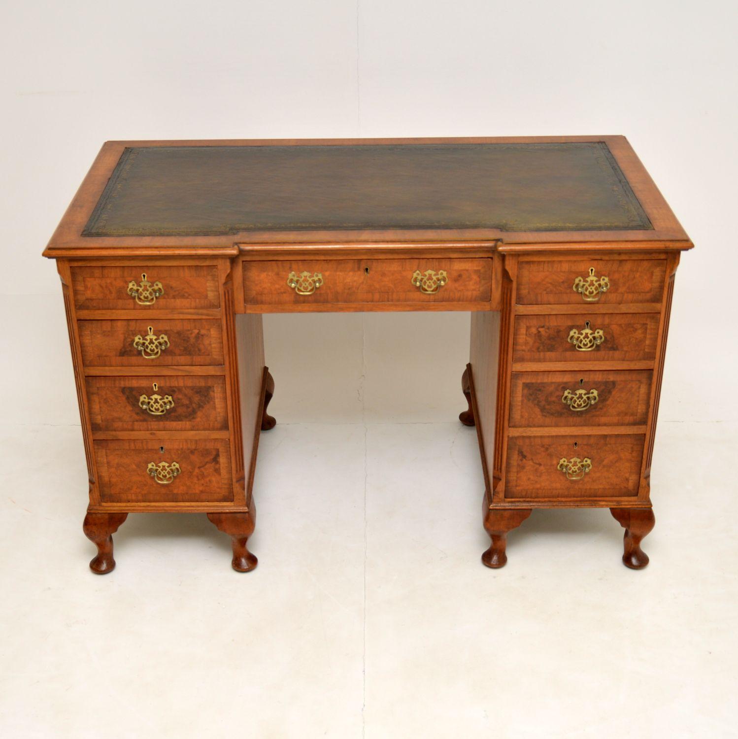 A stunning antique inverted breakfront pedestal desk in walnut, dating from around the 1910-1920’s period.

It is of excellent quality throughout, with a solid walnut construction and beautiful inlaid burr walnut veneers on the drawers fronts.