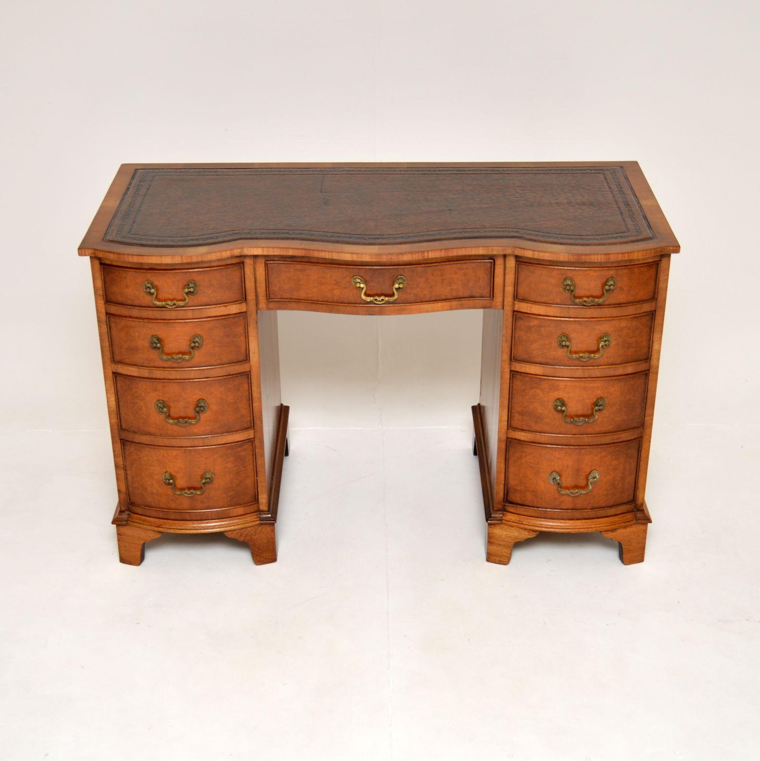 A stunning antique leather top pedestal desk in burr walnut. This is in the Georgian style, it dates from around the 1930-50’s.

The quality is superb, this has a gorgeous inset leather writing surface with tooled edges. There are amazing burr