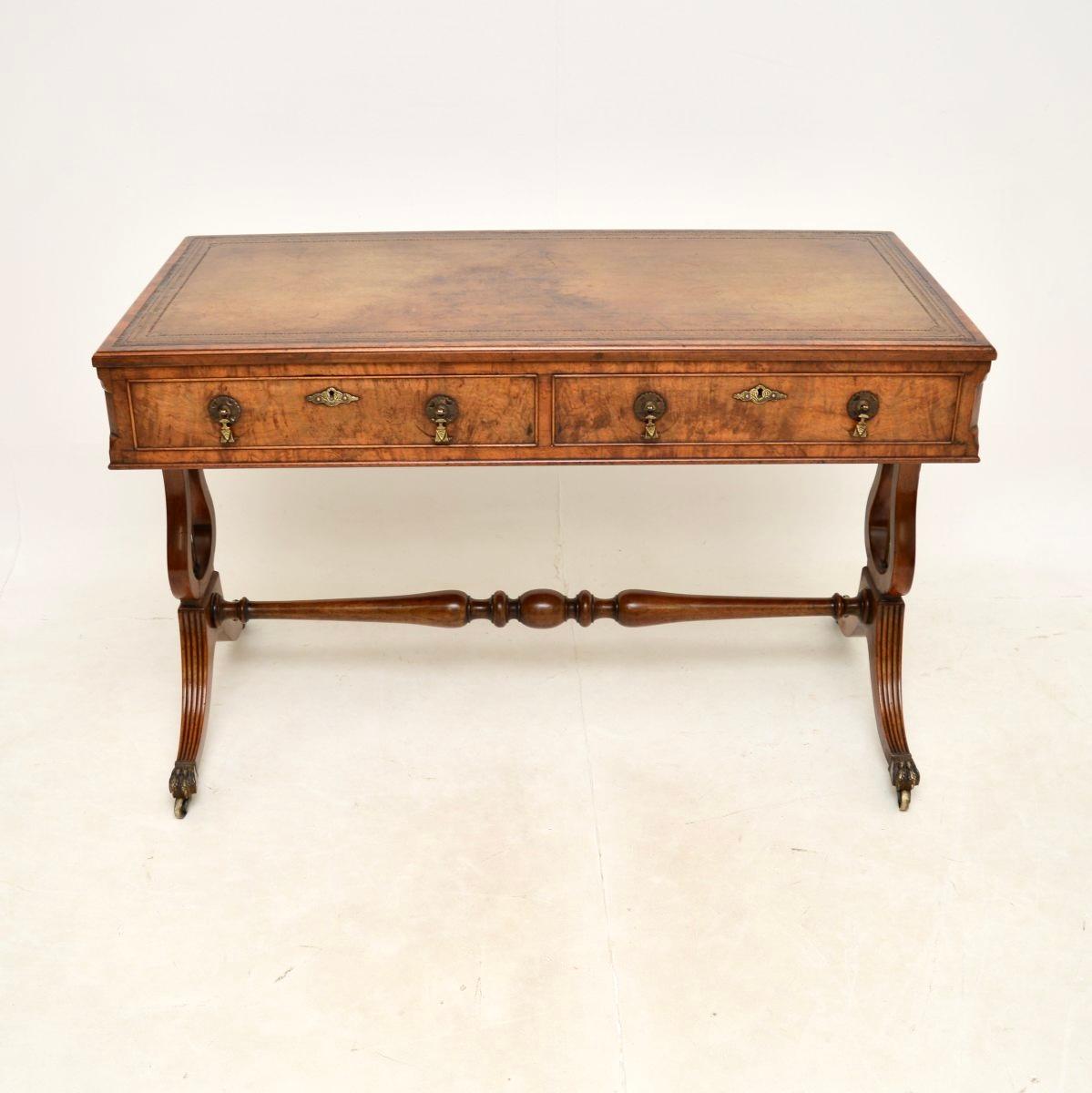 An outstanding antique figured walnut leather top writing desk. This was made in England, it dates from the 1890-1900 period.

It is of superb quality, there are stunning burr walnut grain patterns, this stands on a stretchered base with harp shaped