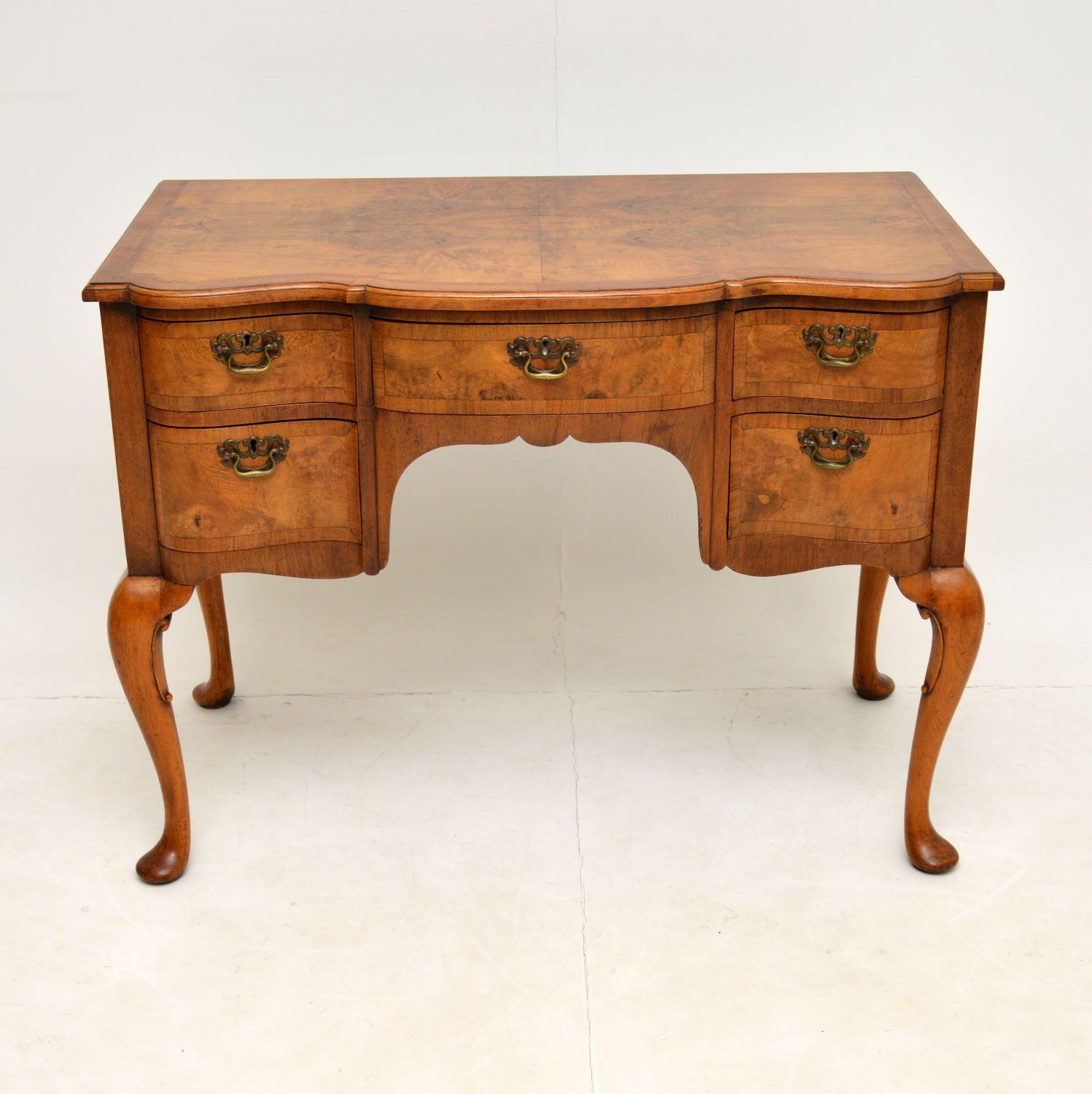 A stunning antique lowboy in burr walnut, in the Georgian style. This dates from around the 1900-1920 period & was made in England.

This is of extremely fine quality, with beautiful burr walnut veneers on solid walnut construction. The top is