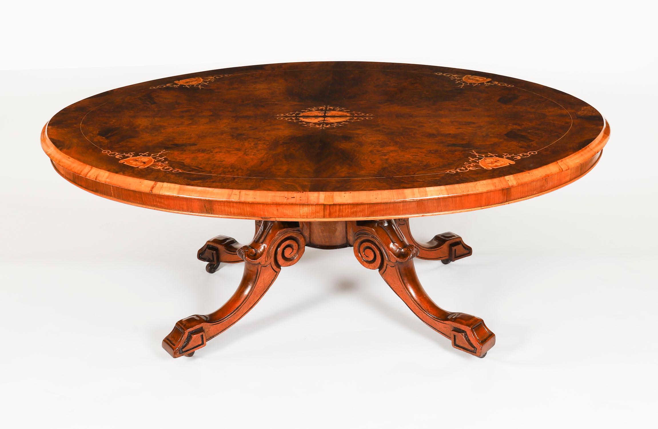This is a superb Victorian burr walnut and marquetry coffee table, circa 1870 in date.

The table top is oval in shape and features wonderful burr walnut with superb marquetry inlaid decoration.

The base is hand carved from solid walnut and the