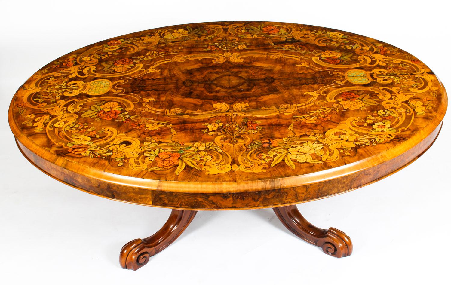 This is a superb Victorian burr walnut and marquetry coffee table, circa 1860 in date.

The tabletop is oval in shape and features wonderful burr walnut with superb floral marquetry inlaid decoration. It is raised on a base that is hand carved