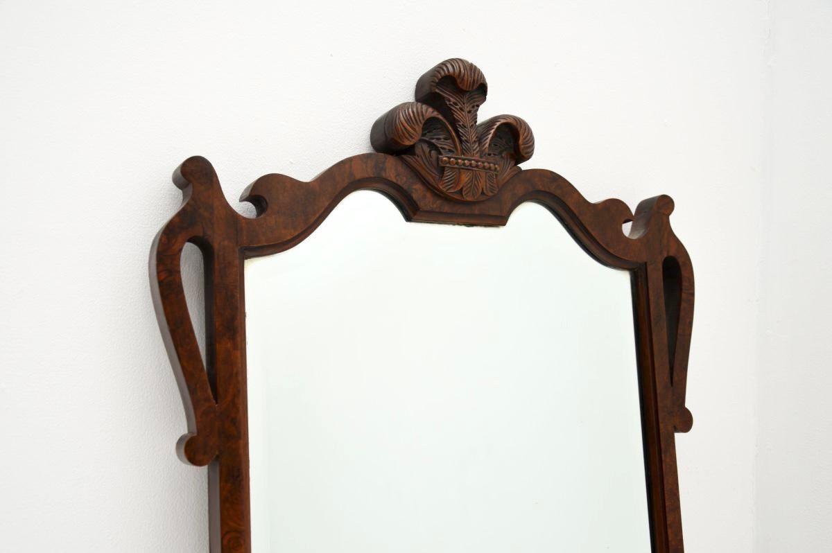 A smart and very well made antique burr walnut mirror. This was made in England, it dates from around the 1920-30’s.

It is of superb quality, with stunning burr walnut grain patterns and a bevelled glass mirror. The top section has beautiful and