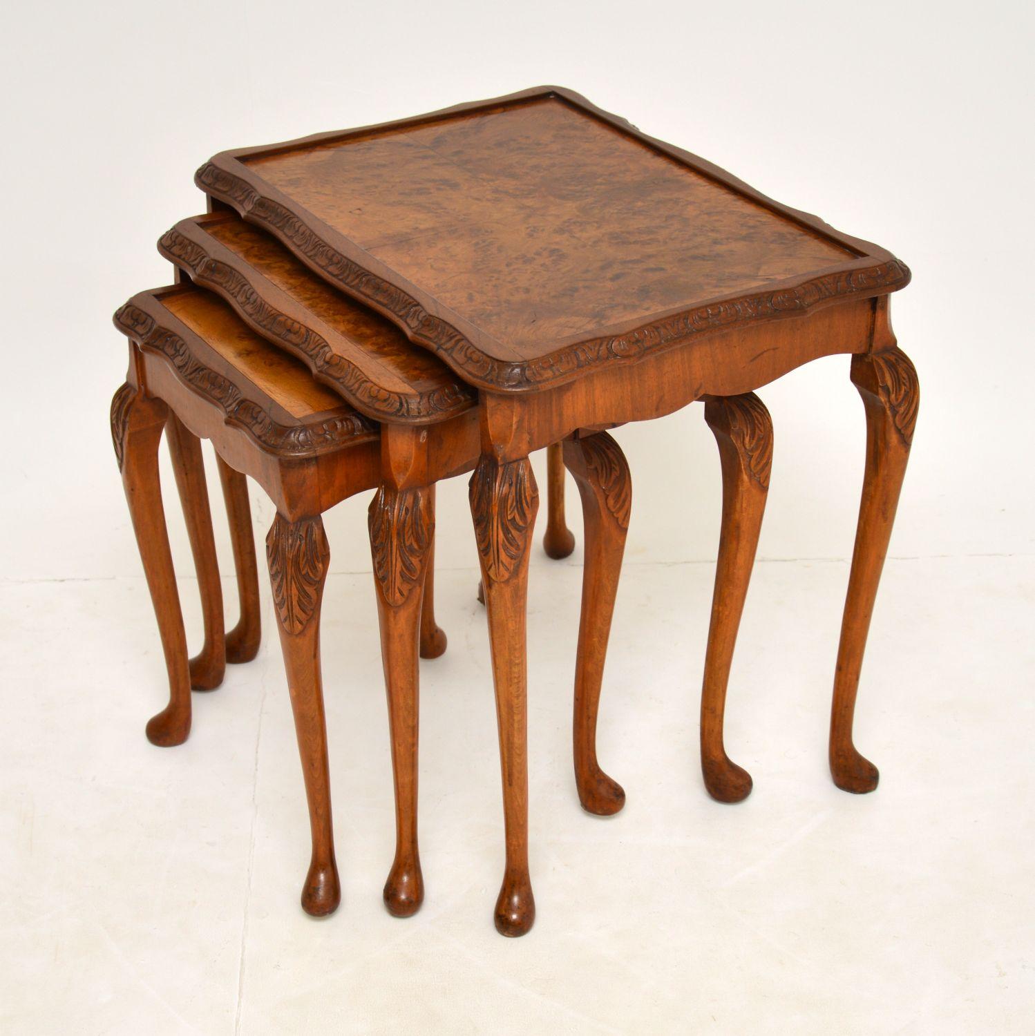 A beautiful burr walnut nest of three tables in the antique Queen Anne style. These date from around the 1930' period.

The quality is superb, with lovely carving around the edges. They are built from solid wood, with stunning burr walnut veneers