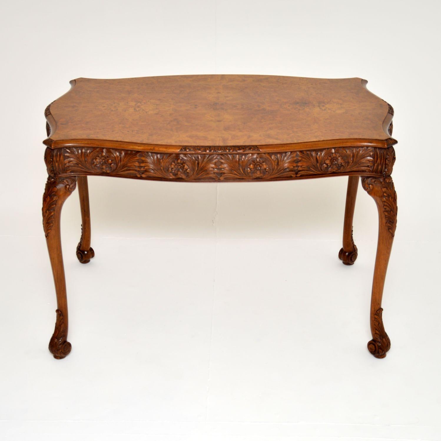 A magnificent antique carved walnut occasional table in the Queen Anne style. This was made in England, it dates from around the 1920’s period.

It is of superb quality, with stunning and intricate carving around all the edges, on the tops &