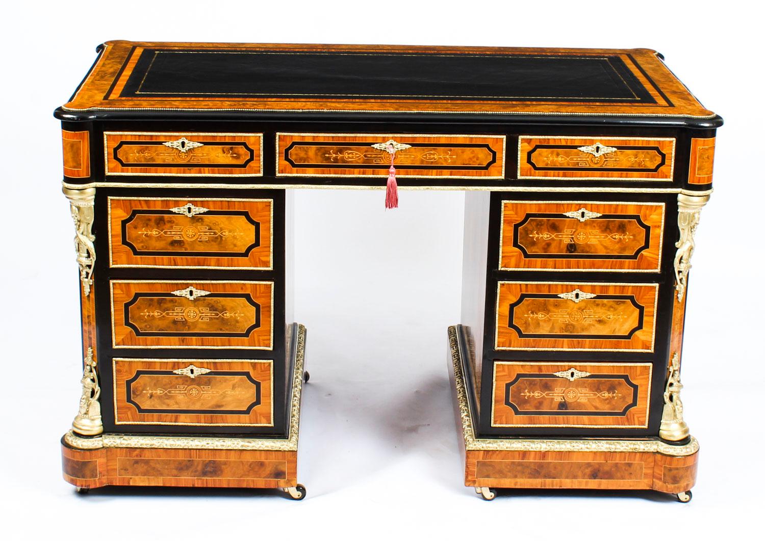 A beautiful Victorian burr walnut, olivewood, ebonized and ormolu-mounted pedestal desk, attributed to Holland & Sons, circa 1870 in date.

The rectangular top with an inset black gilt tooled leather writing surface above three frieze drawers with
