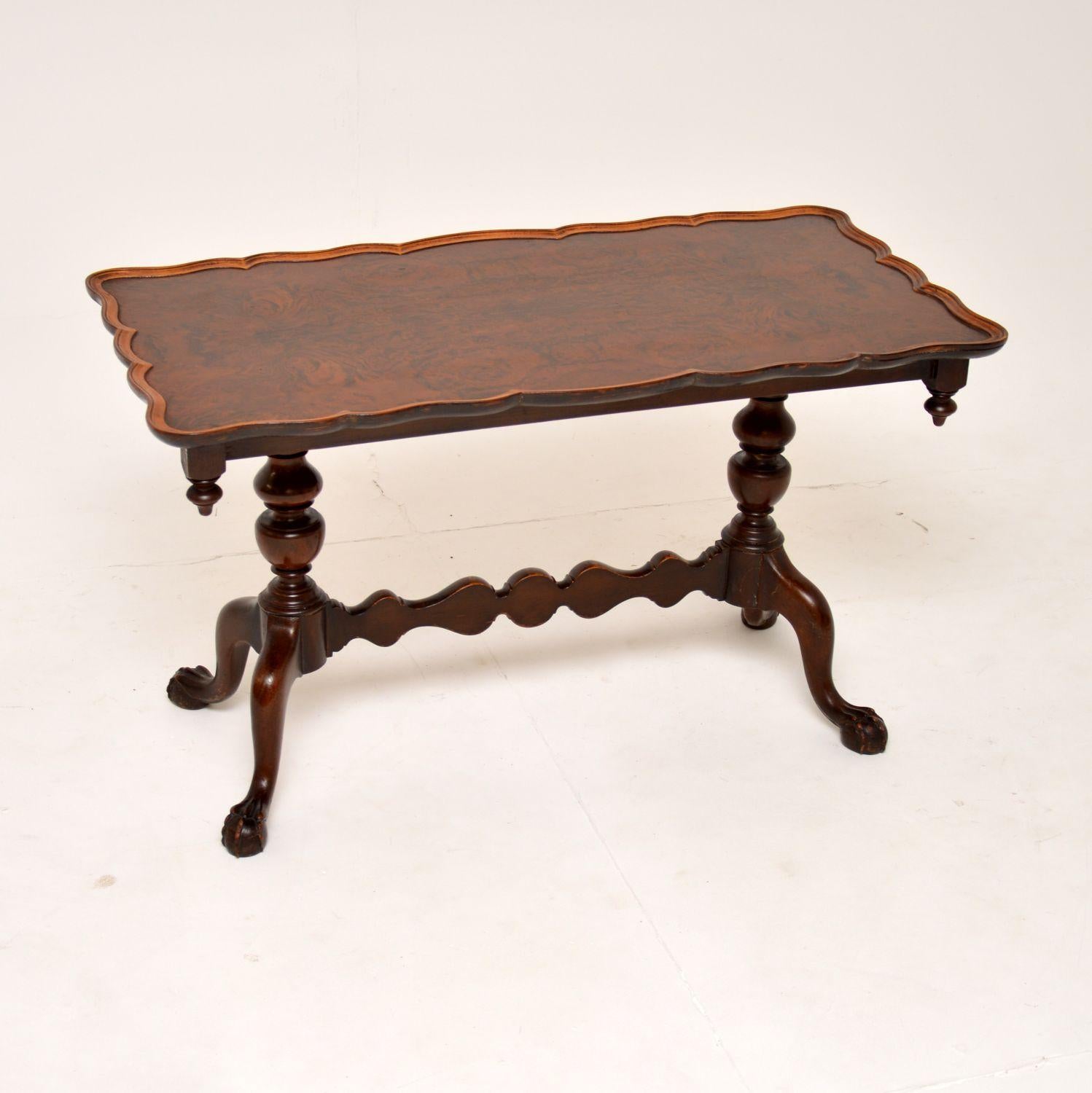 A stunning antique walnut coffee table, made in England and dating from the 1920-30’s.

This is beautifully made, with a lovely pie crust top and a shaped stretchered base, terminating in claw and ball feet. The burr walnut grain patterns on the