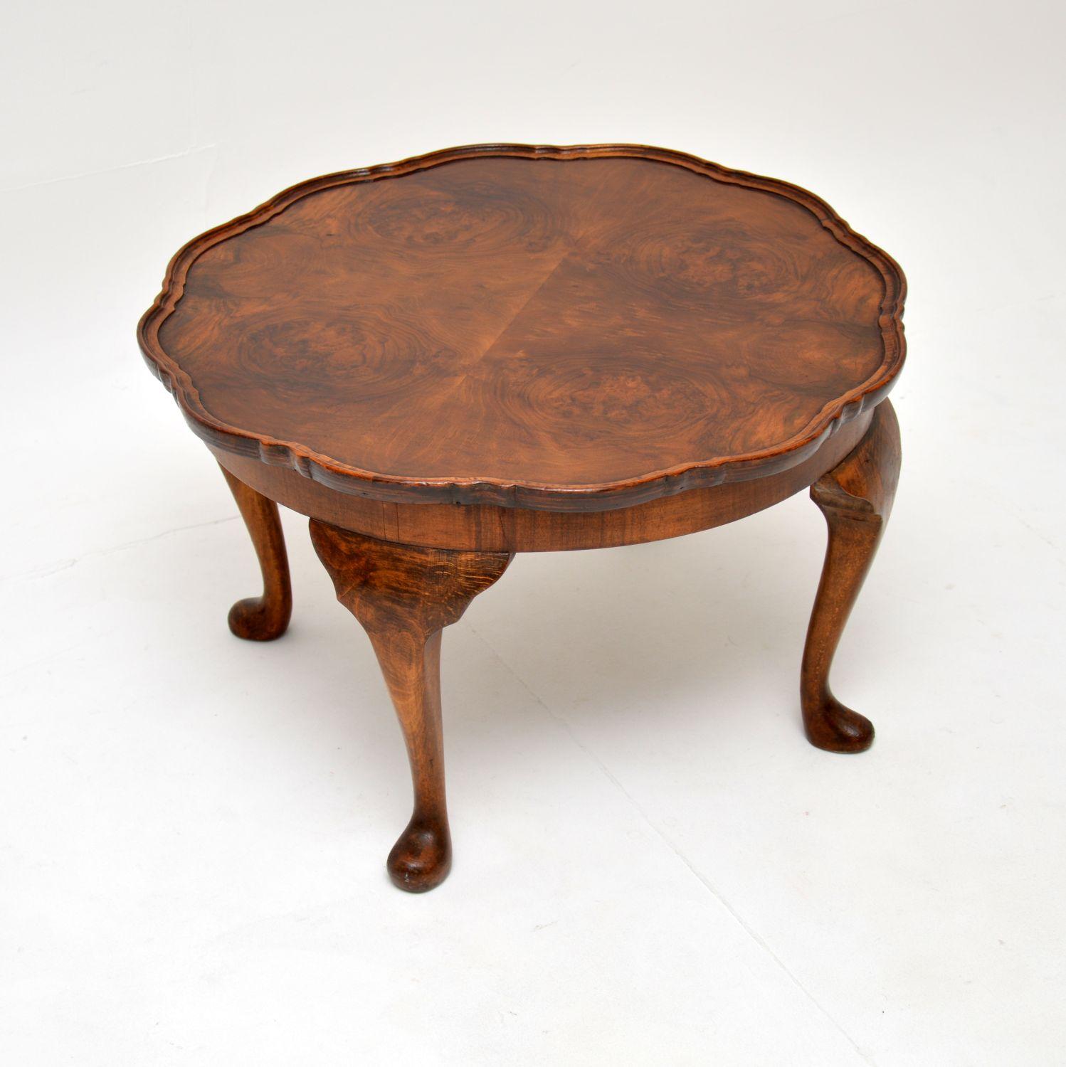 A lovely antique burr walnut circular coffee table with a raised pie crust edge. This was made in England, it dates from the 1920-30’s.

It is of very good quality and is a very useful size. The top has stunning burr walnut grain patterns, this sits
