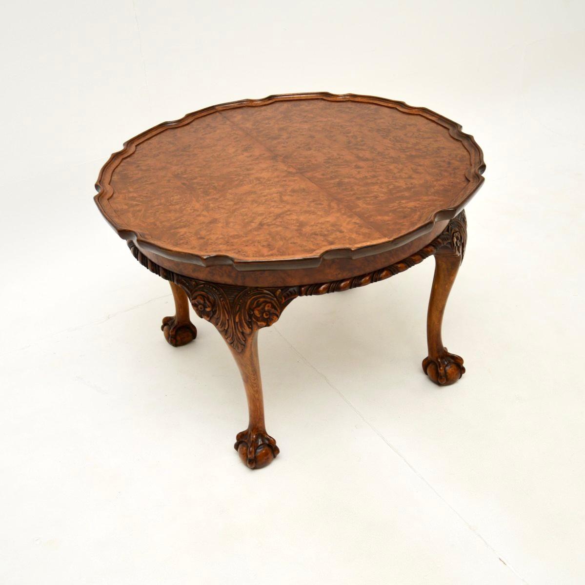 A beautiful antique burr walnut pie crust coffee table. This was made in England, it dates from the 1920’s.

The quality is outstanding, this is extremely made and is an impressive size. The circular top has a raised pie crust edge and stunning burr