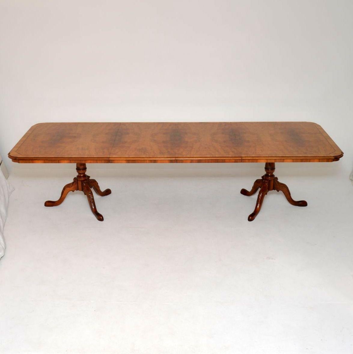 Magnificent large dining table and matching chairs in walnut and burr walnut, with an extendable table that can comfortably seat ten people. The chairs have very wide proportions & are carved on the backs, plus on the tops of the legs too. The