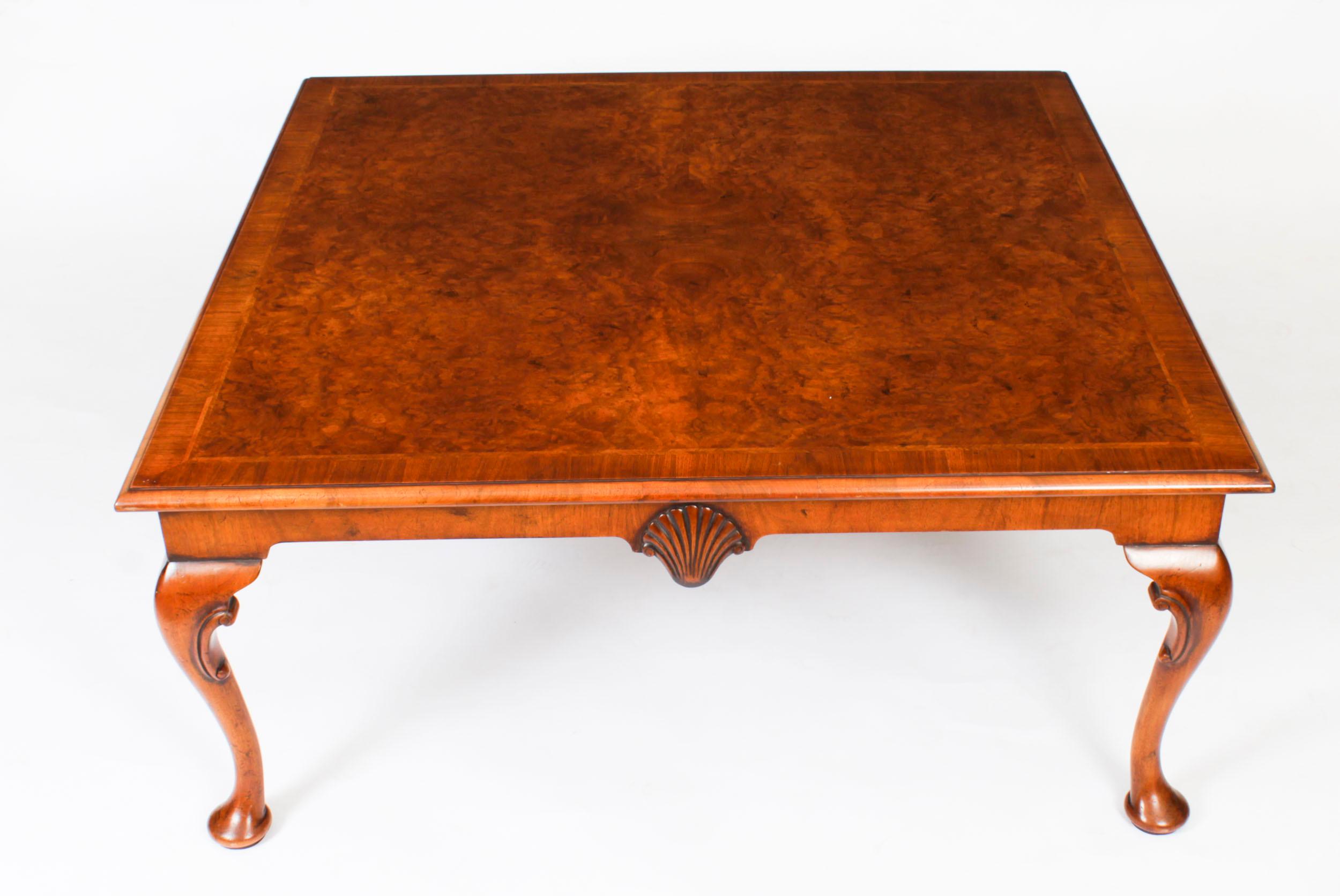 This is a stunningly beautiful English antique burr walnut coffee table, circa 1920 in date. 

It features a quarter veneered burr walnut, crossbanded and feather banded top with a moulded edge above a carved frieze, standing on well carved