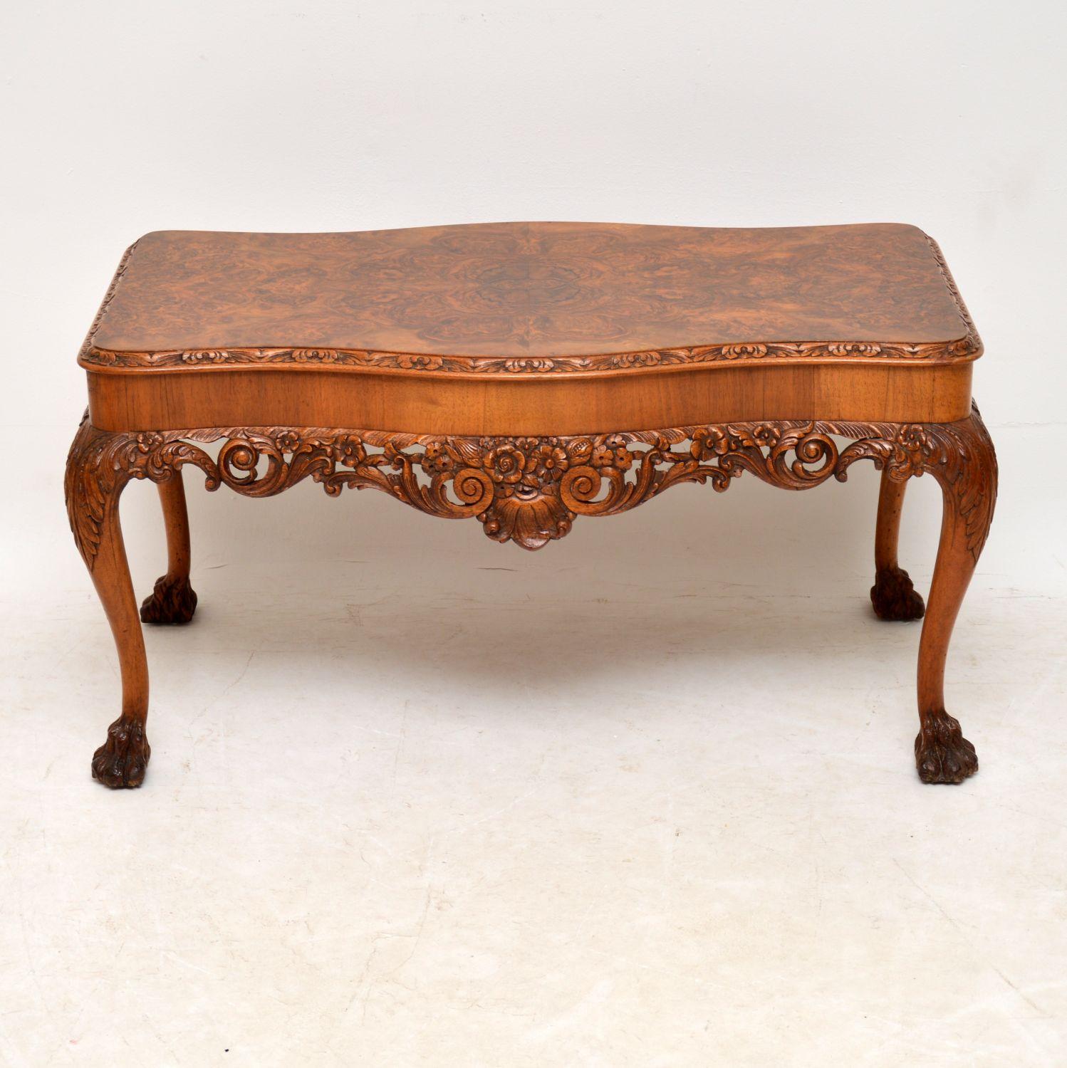 This antique walnut Queen Anne style coffee table has some fabulous carvings all-over and even has carved hairy paw feet. The top is a beautifully patterned burr walnut. This table is in excellent original condition and dates to circa 1920s-1930s