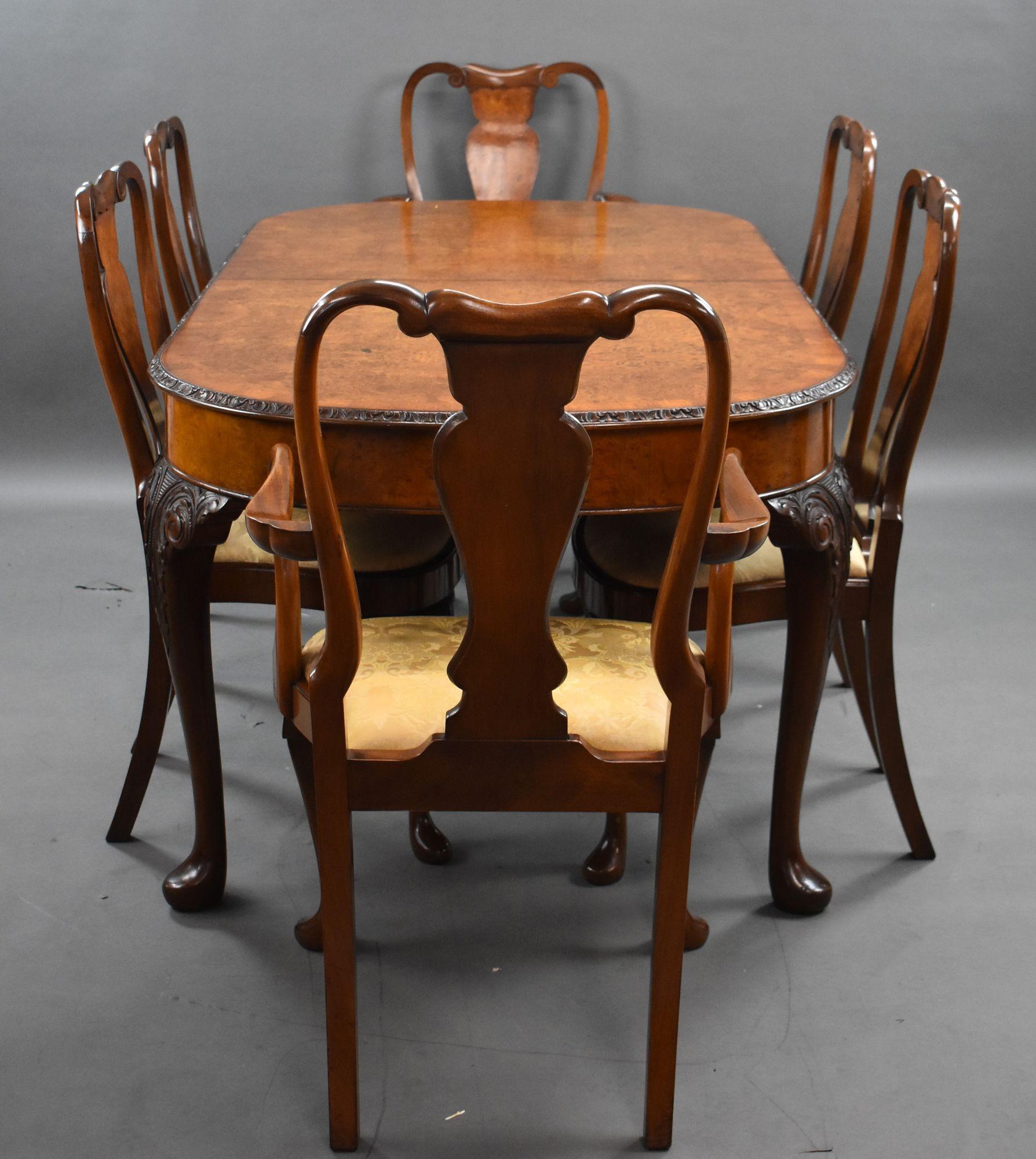 For sale is a good quality antique Queen Anne style burr walnut dining suite, consisting of an eight seat dining table, matching sideboard and set of 6 walnut chairs. The sideboard has an arrangement of three doors flanked by cupboards, over a