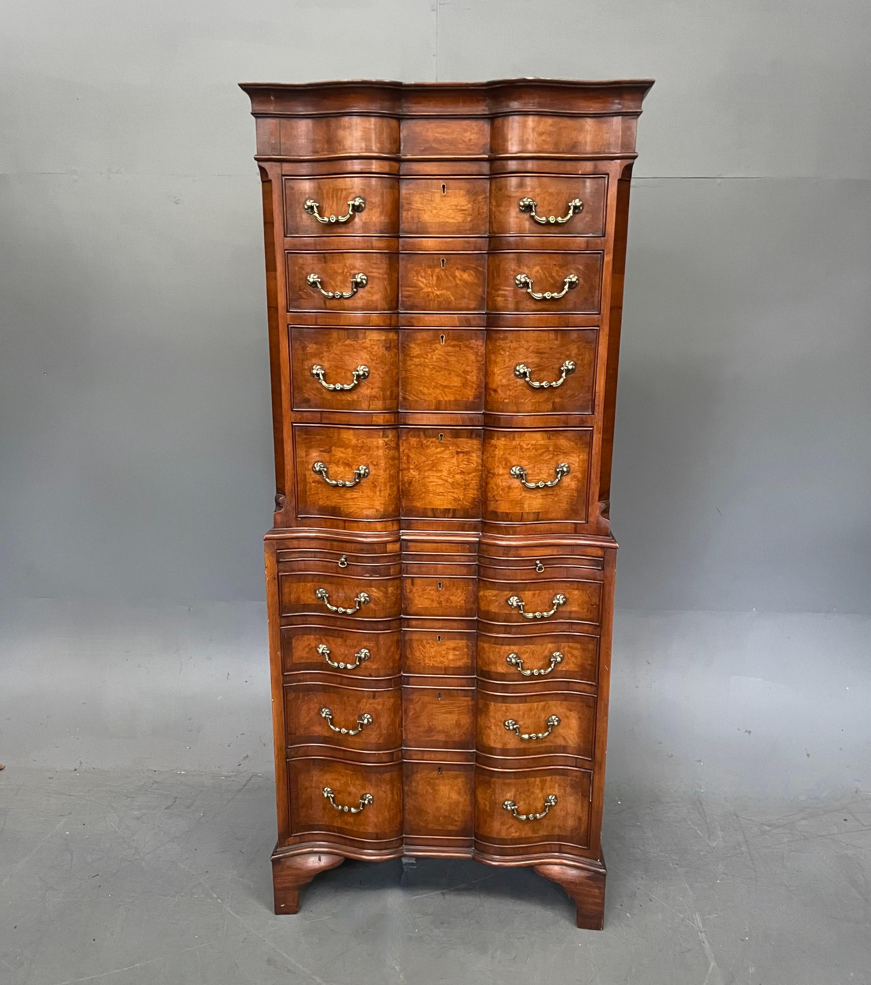 Good quality burr walnut tall boy chest on chest which has a wonderful shaped front with 8 graduating drawers that are hand dovetail jointed with wonderful decorative brass swan neck handles. It has a central brushing slide. It has a great colour