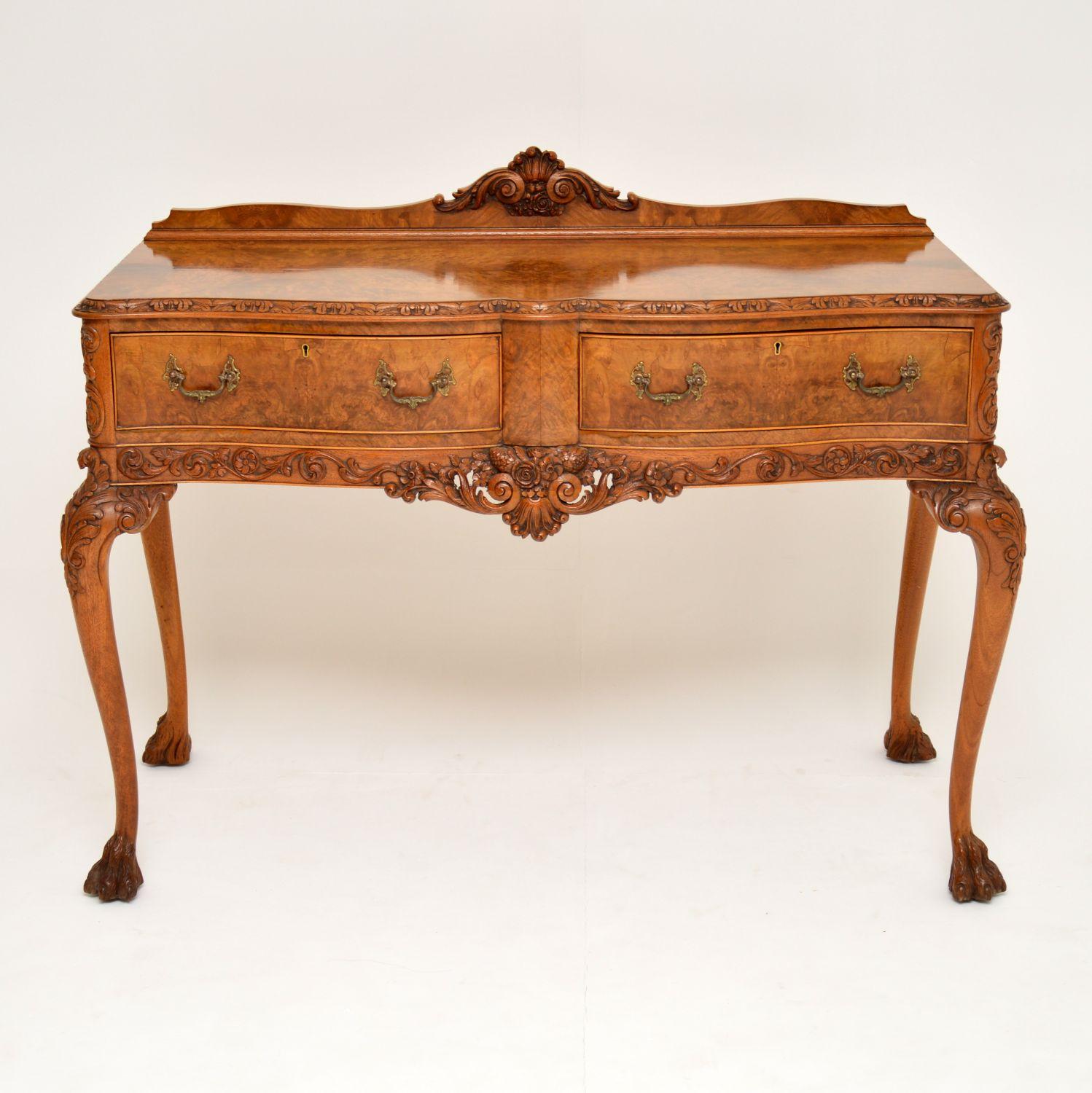 This antique Queen Anne style burr walnut server or console table is superb quality and has some wonderful details. It dates from circa 1920s period and has just been French polished, so is in excellent condition. The hand carving is of the highest