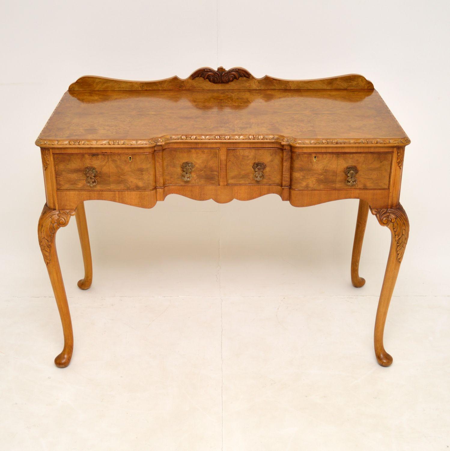 A gorgeous antique server side table in walnut, made in the Queen Anne style. This dates from the 1920-30’s, it was made in England by Epstein.

The quality is amazing, with stunning grain patterns and lovely carving around the edges. This