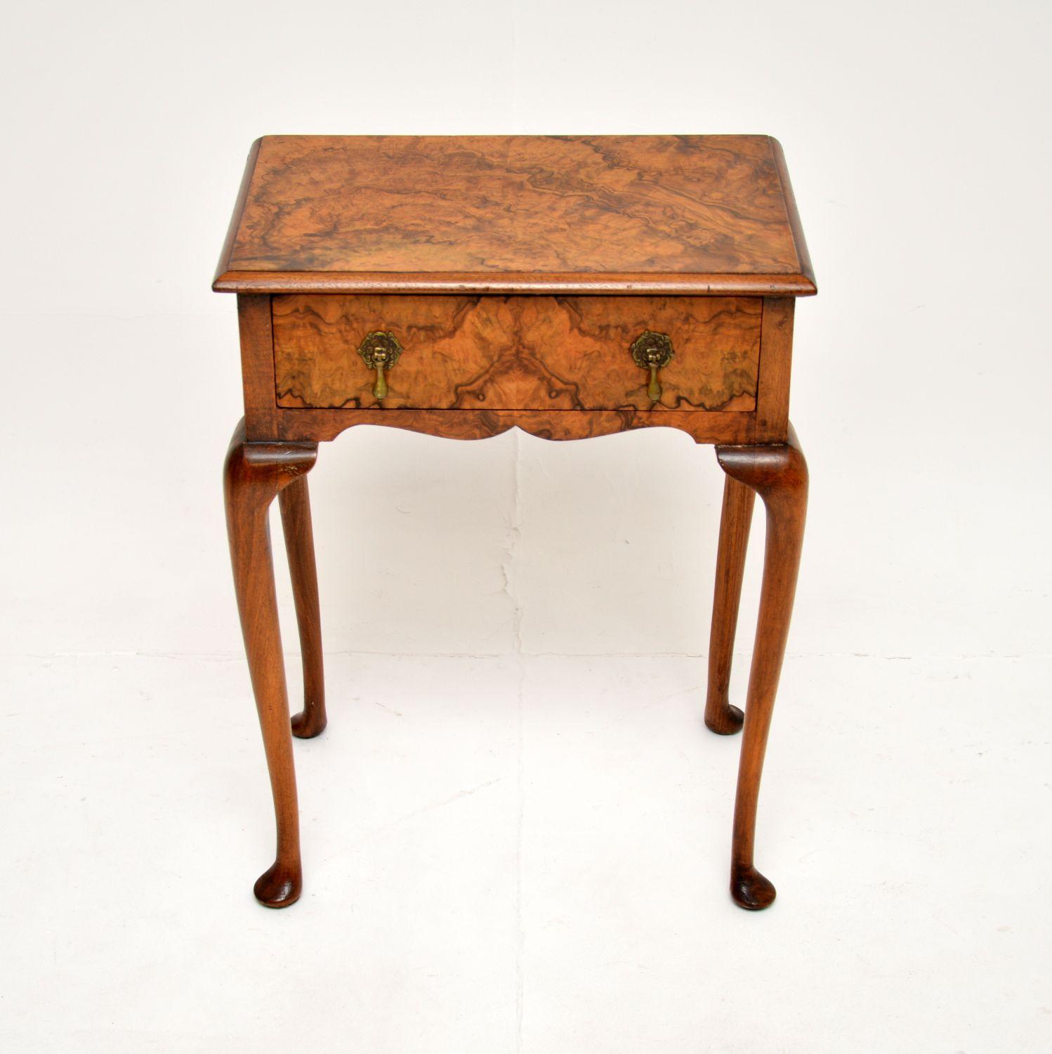 A beautiful antique burr walnut side table, made in England and dating from around 1900-1910.

It is of lovely quality, with stunning burr walnut grain patterns. There is a single drawer with solid brass tear drop handles, the back is also nicely