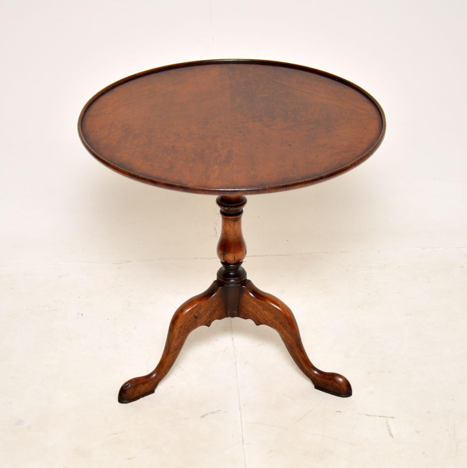 A lovely antique walnut occasional table in the Georgian style. This was made in England, it dates from around the 1930’s.

The quality is excellent and this is a very useful size. The burr walnut revolving top can tilt upwards to save space when