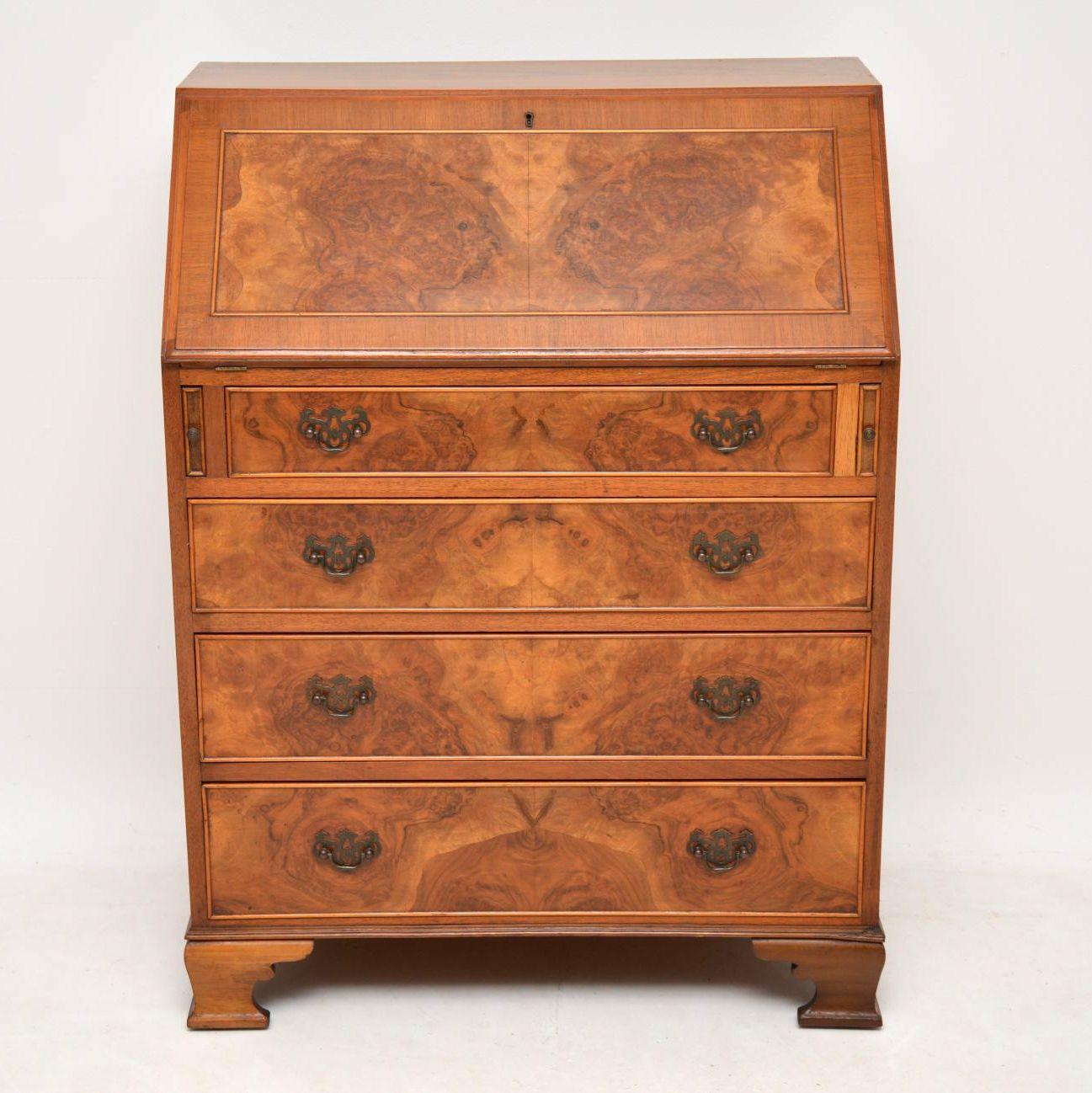 Antique burr walnut bureau in good condition dating from the 1920s period. It has a wonderful color & a lovely grain pattern running through the flap & the drawers. The flap has burr walnut panel with figured walnut crossbanding. The drawers are