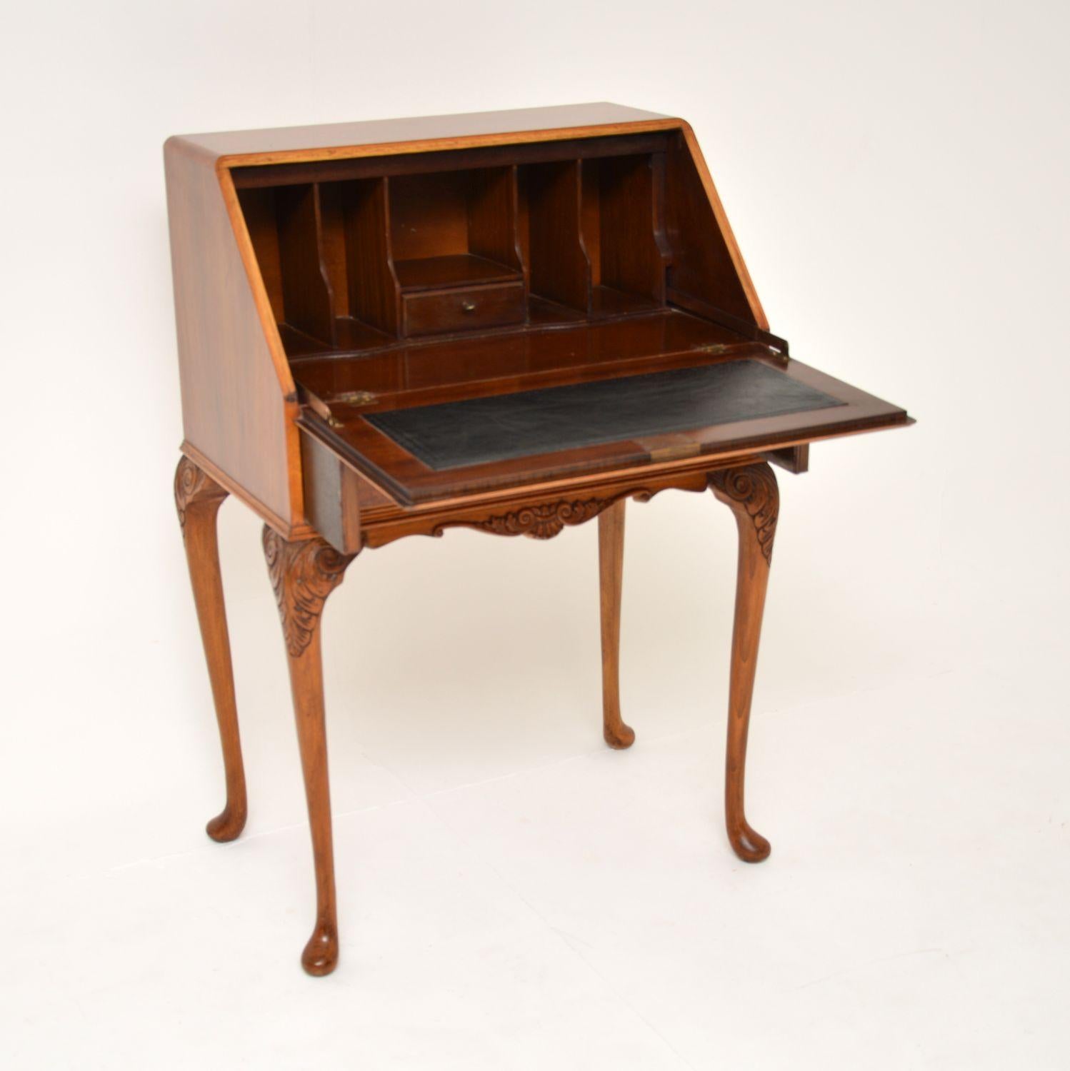 A beautiful antique burr walnut writing bureau in the Queen Anne style. This was made in England, it dates from around the 1930’s.

This is of excellent quality, with a gorgeous and elegant design. The burr walnut grain patterns are stunning