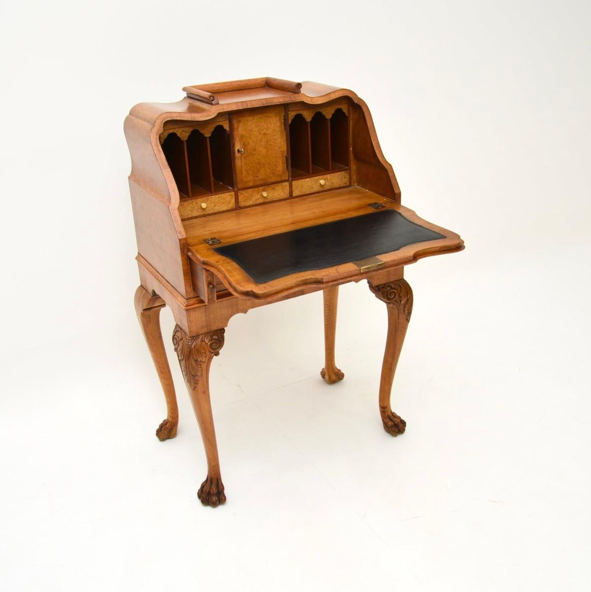 A superb antique burr walnut writing bureau, made in England and dating from the 1920-30’s.

It is of outstanding quality, with a beautiful and practical design. The burr walnut grain patterns are gorgeous, this stands on cabriole legs with hairy