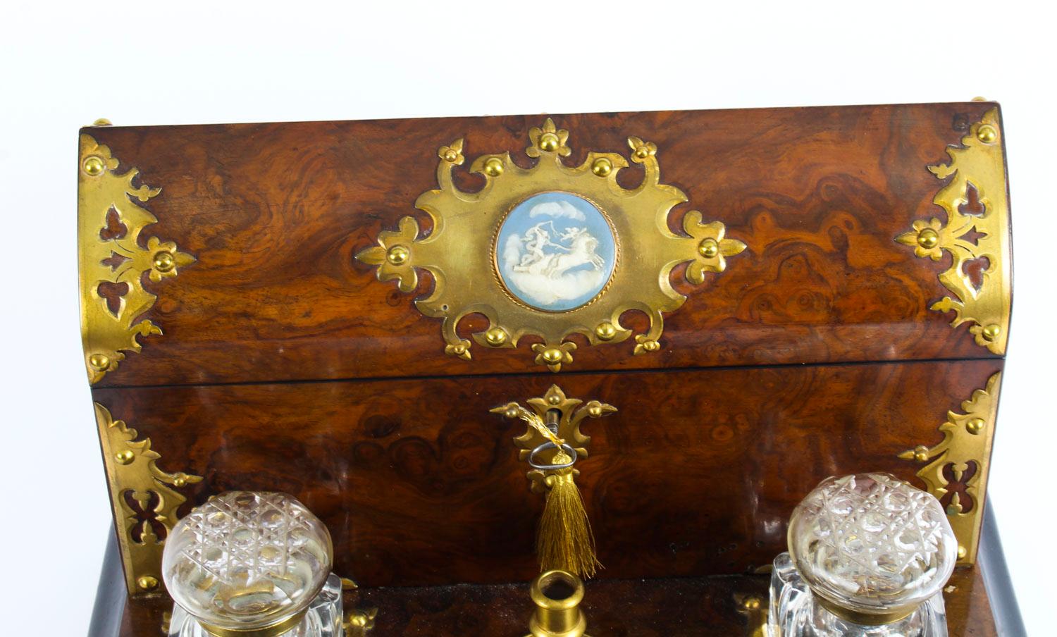 This is a fabulous antique Victorian burr walnut writing and stationery box of domed form with elaborate decorative brass mounts and Wedgwood plaque, circa 1860 in date.

The back with arched cover enclosing a paper and envelope holder with the