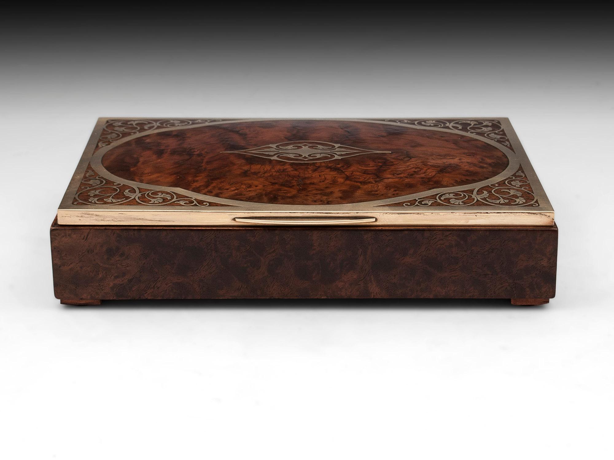 Burr Yew jewelry box with bold brass edging and inlay.
The interior is lined with white silk and luxurious teal padded velvet to help keep protect your precious items.
    