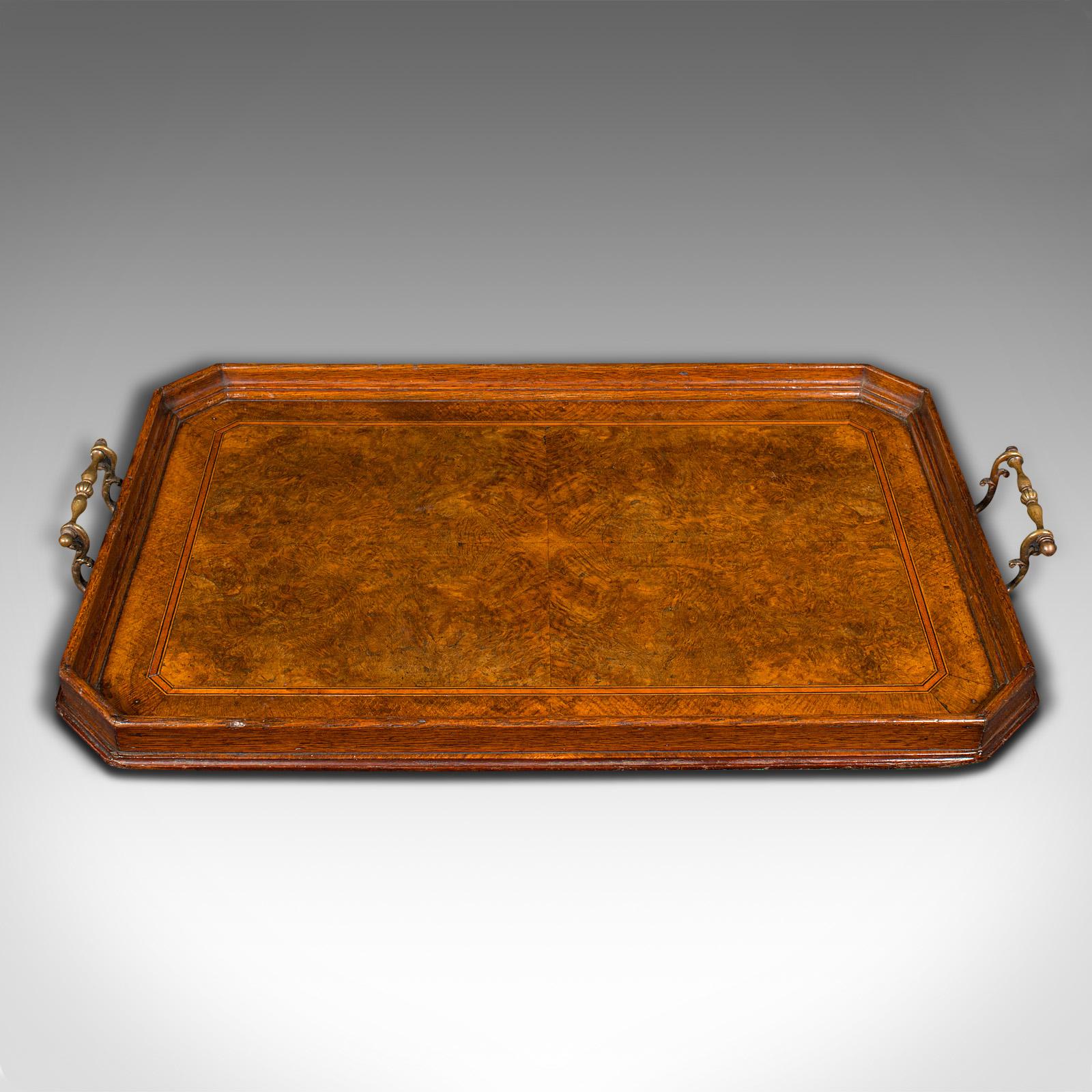 This is an antique butler's serving tray. An English, oak and bookmatched walnut afternoon tea platter, dating to the late Victorian period, circa 1900.

Serve in style with this exquisite Victorian showpiece tray
Displays a desirable aged patina