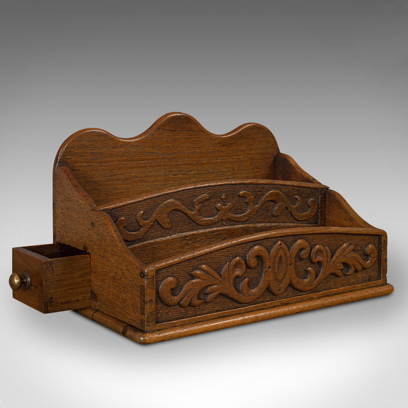 This is an antique butler's stationery tidy. An English, oak storage box in Arts & Crafts taste, dating to the late Victorian period, circa 1900. 

Appealing carved details
Displays a desirable aged patina
Oak shows fine grain interest
Dovetail