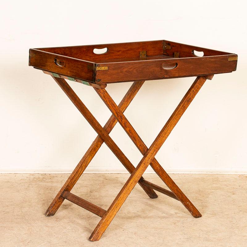 Original English mahogany butler's table with removeable tray that rests on Stand. Tray has cut out handles on each side. Any scratches/knicks are age-related and do not detract from the beauty nor function of this table that is strong/stable and