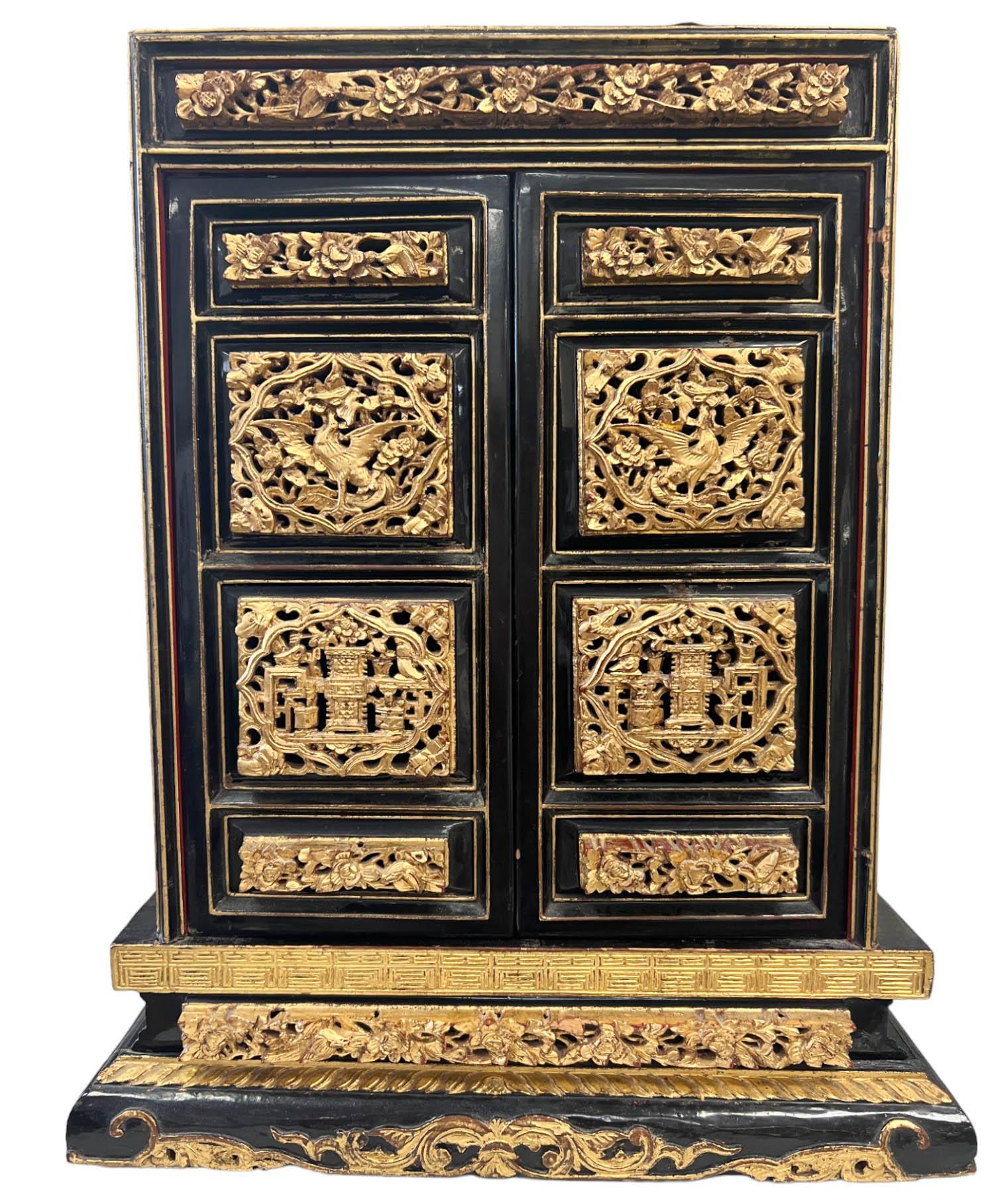 The Antique Butsudan Shrine is a remarkable piece of religious and cultural significance. Crafted with exquisite attention to detail, the cabinet showcases intricate wood carvings that adorn its exterior, creating a visually stunning and ornate