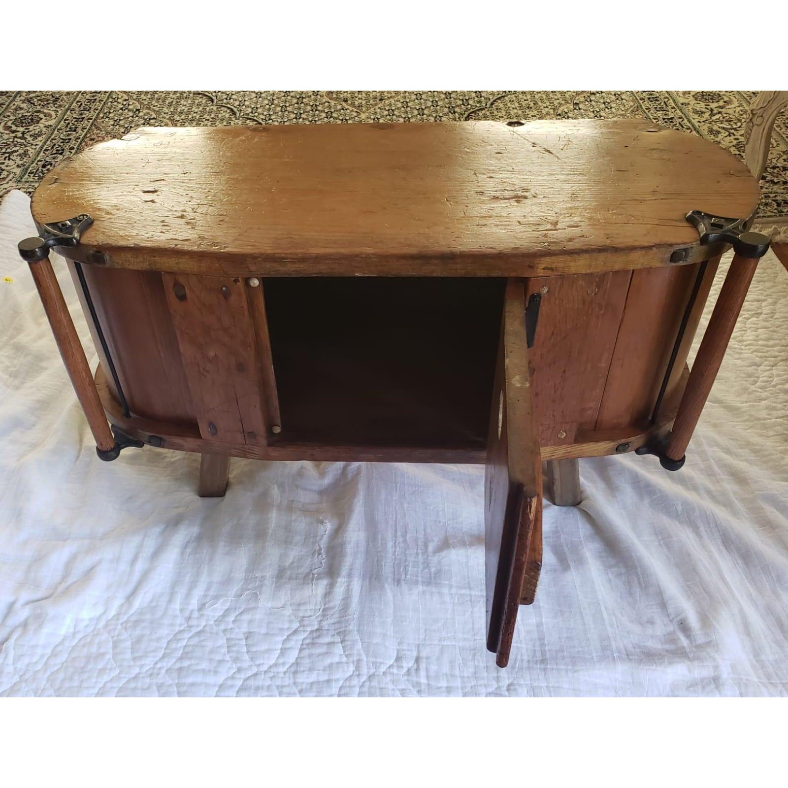 Antique butter churn table cabinet with center door that opens for storage.
One door in front. Handle on each side of front. Some scratches and age seams.
Measures 36