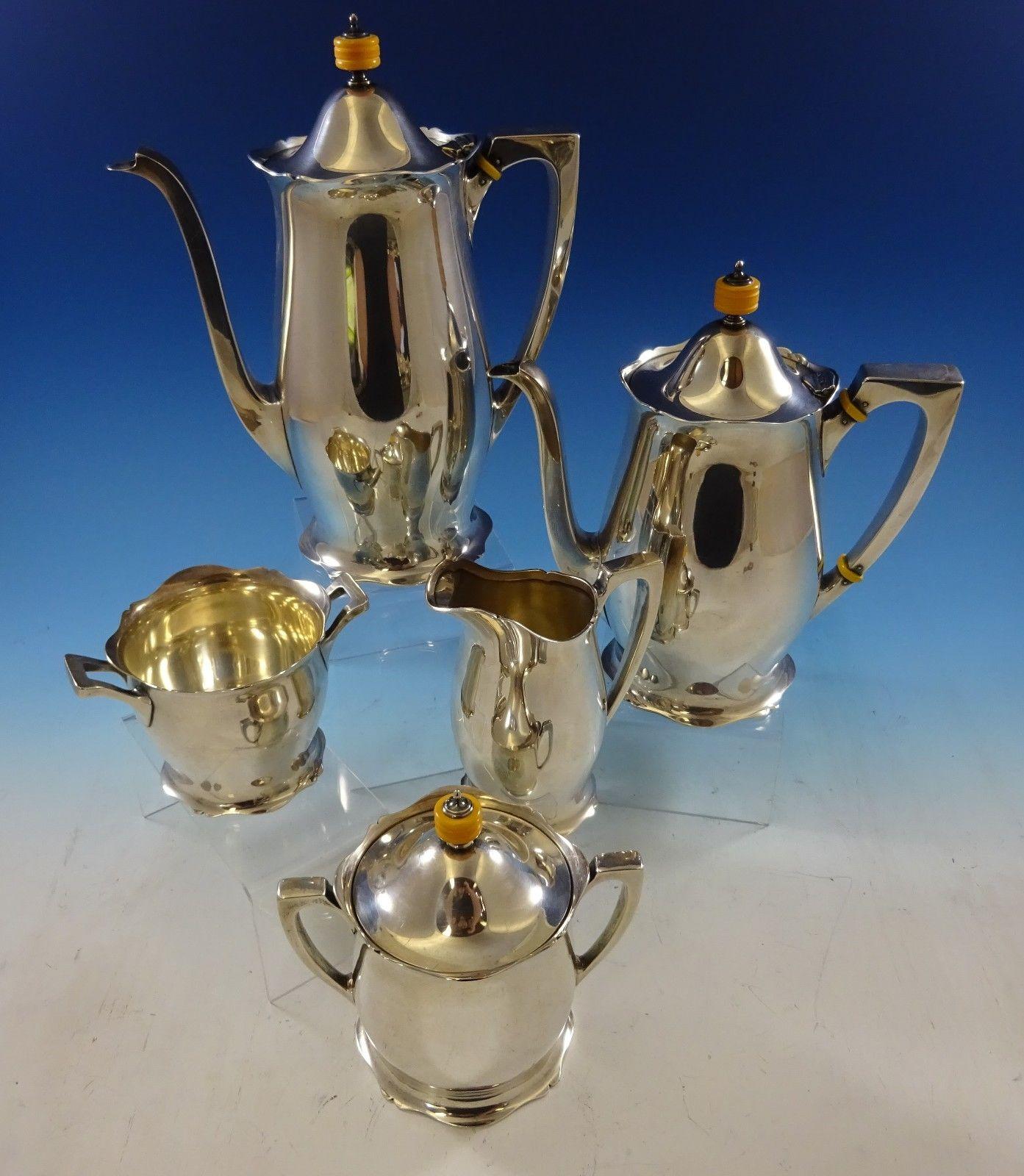 Antique by Wallace
Beautiful antique by Wallace sterling silver tea set 5-piece with bakelite finials. The set includes:
1 - Coffee pot: Measures 8 1/2 x 10 and weighs 27.17 troy ounces.
1 - Tea pot: Measures 8 1/2 x 9 and weighs 26.08 troy