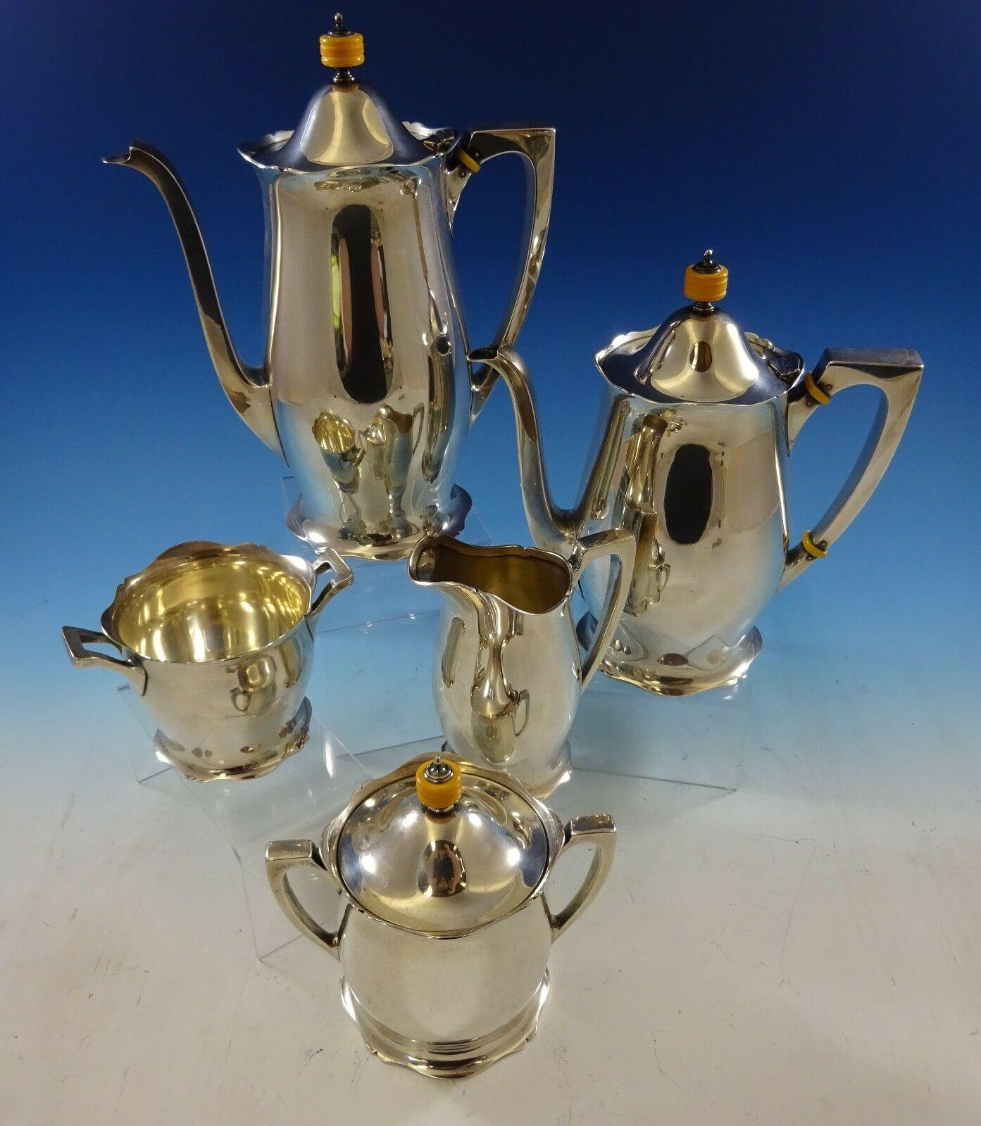 Antique by Wallace

Beautiful antique by Wallace sterling silver tea set 5-piece with bakelite finials. The set includes:

1 - Coffee pot: Measures 8 1/2