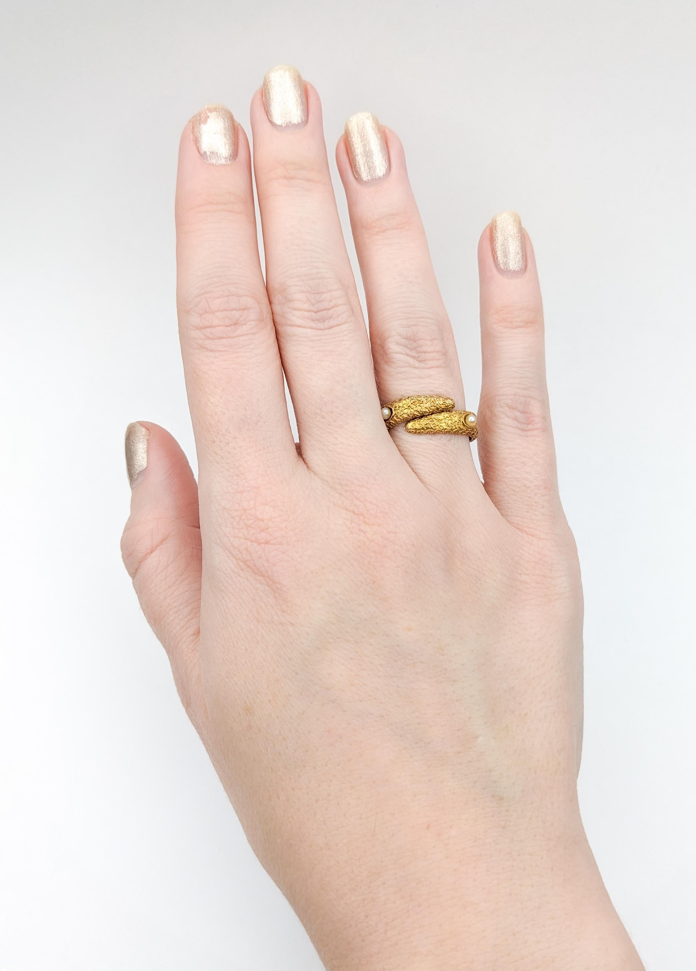 Antique Bypass Seed Pearl Coral Textured Ring

Discover timeless elegance with our antique bypass ring, a testament to exquisite craftsmanship. Delicately crafted in 14k yellow gold, the centerpiece of this ring is adorned with lustrous pearls,