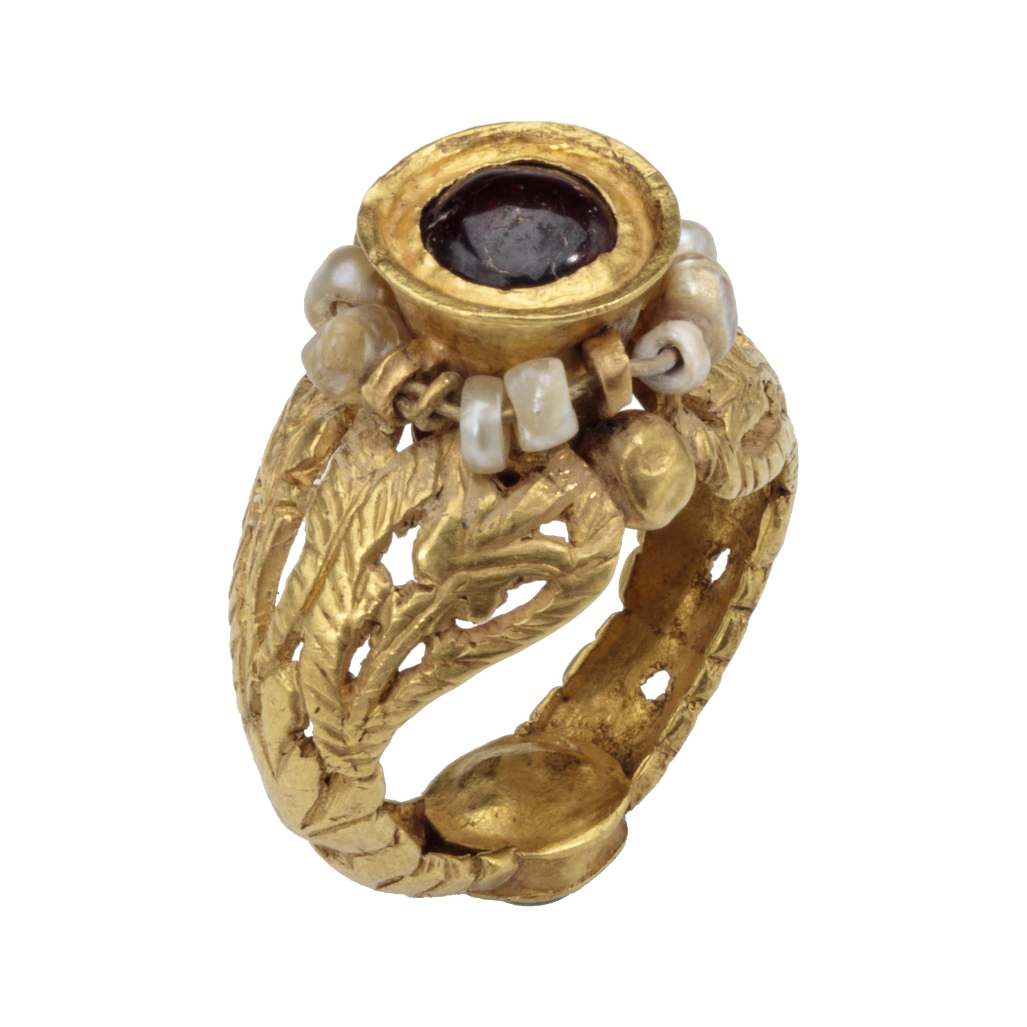 Openwork Double Gemstone Ring of Garnet and Emerald
Byzantine Egypt, Alexandria?, 6th – 7th century AD
Height 32 mm., exterior width of hoop 32 mm., bezel diameter 15 x 16 mm.
Weight 10.5 gr., US size 6, UK size L ½

This 'opus interrasile' hoop is