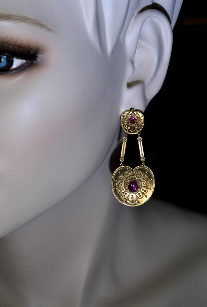 Made in St. Petersburg in the 1880s by one of the best Russian jewelers of the period – Samuel Arnd.

The 14K matte gold earrings are designed in medieval Byzantine style with gold filigree and granulation. The earrings are set with four cabochon