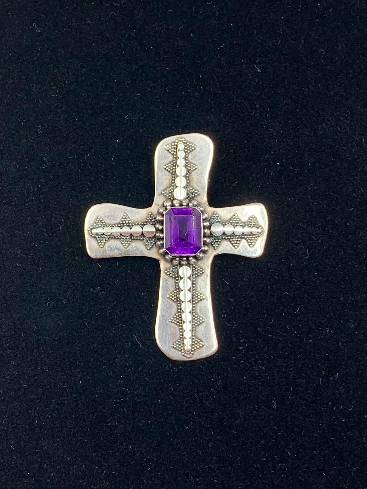 Fine antique sterling silver Byzantine style hand crafted organically shaped cross pendant with a rectangular amethyst center framed by two rows of granulation work, the arms decorated with a beautifully detailed pattern of graduated circles and
